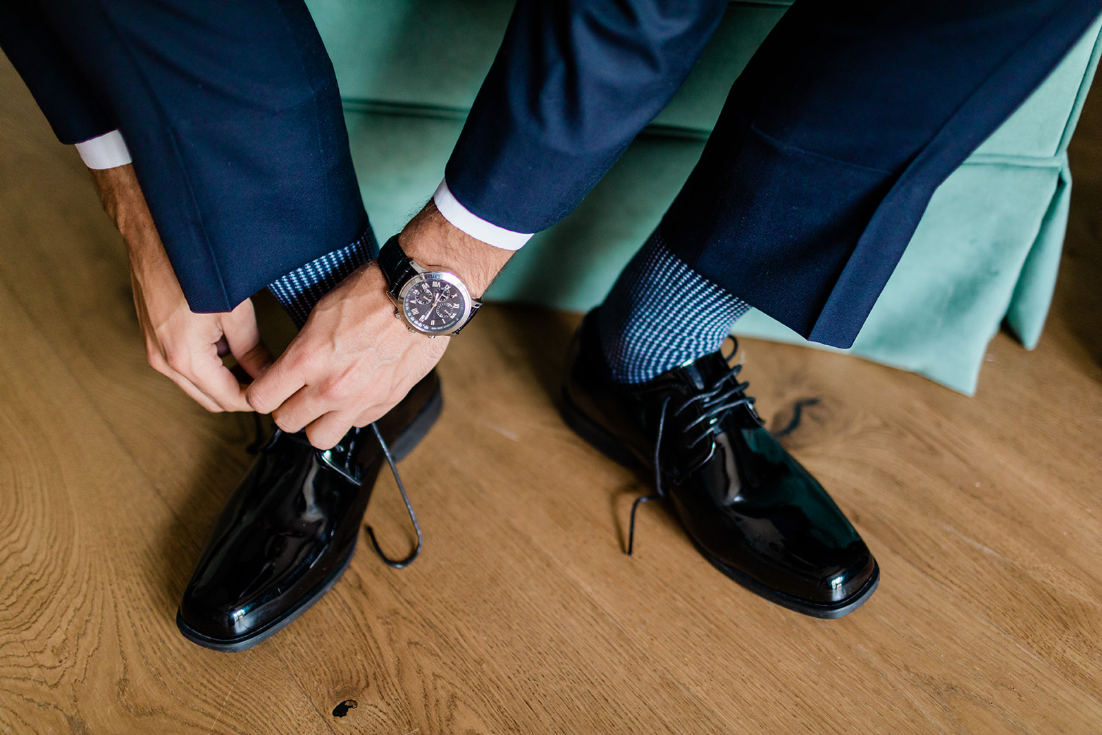groom putting on shoes for wedding ceremony