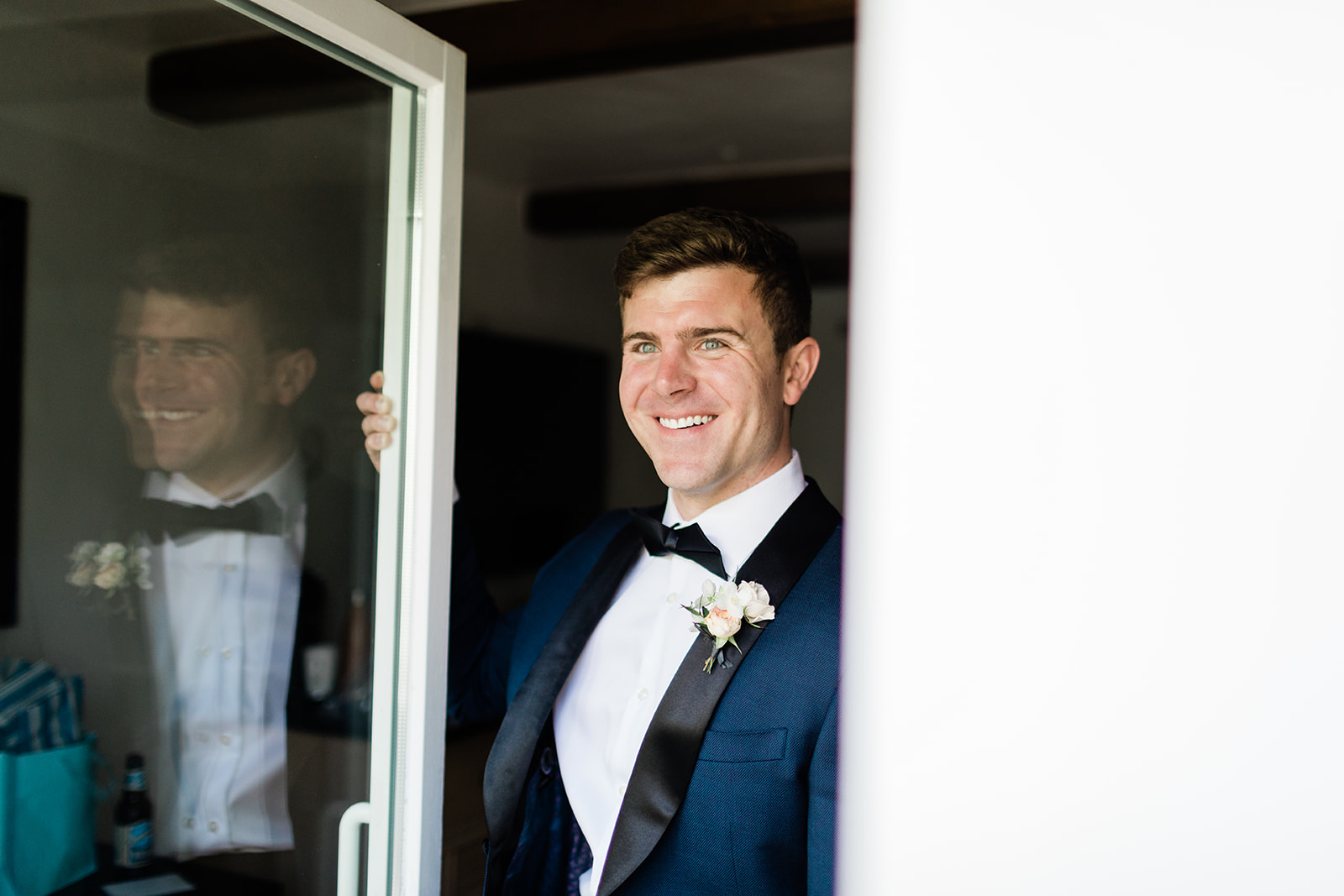 groom gets ready for outdoor Colorado mountain wedding in Vail