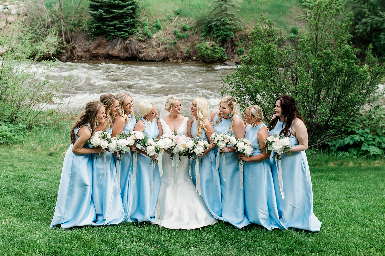 bride and bridesmaids portrait in front of Colorado mountain river