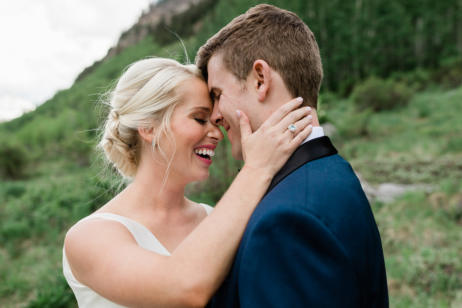 bride and groom snuggle in Vail mountains