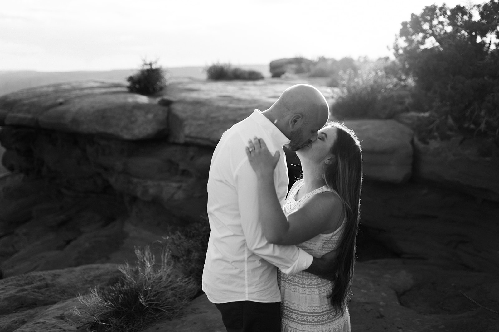 engaged couple kisses in Moab desert adventure session