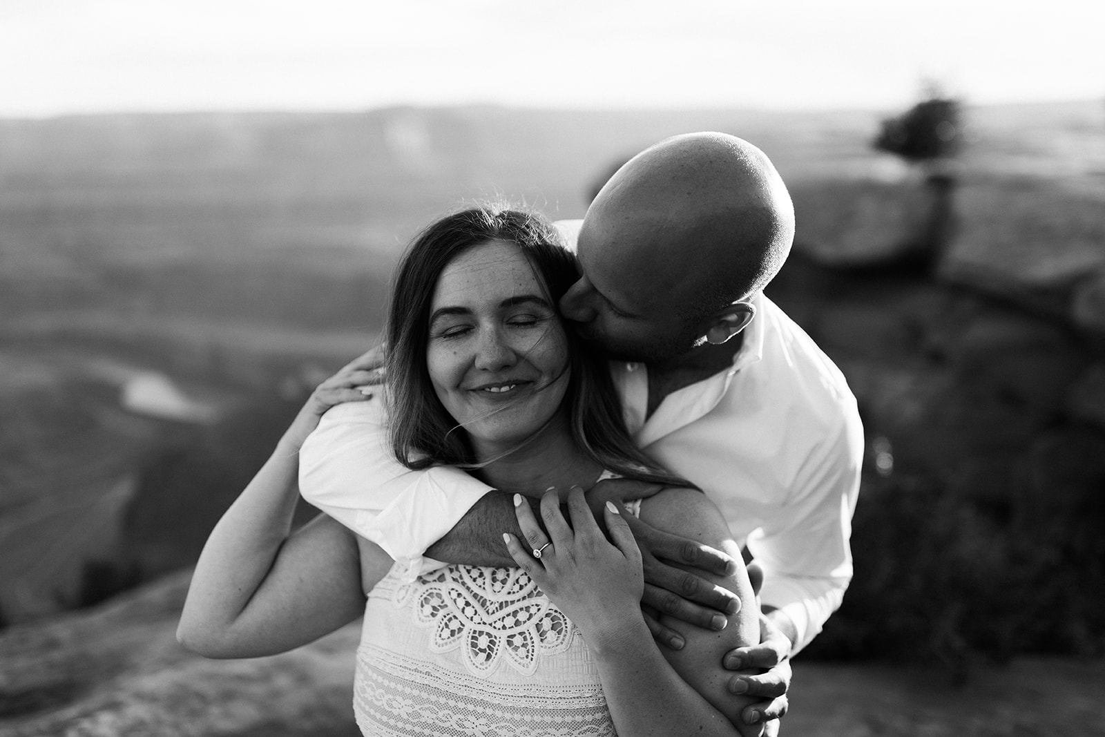 man hugs woman during photography session