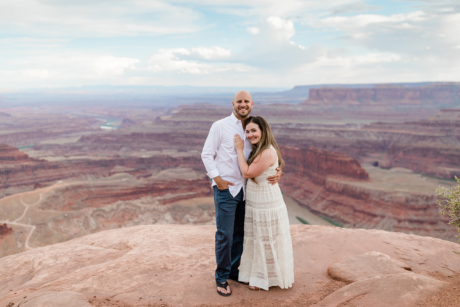engaged couple in front of Moab desert backdrop