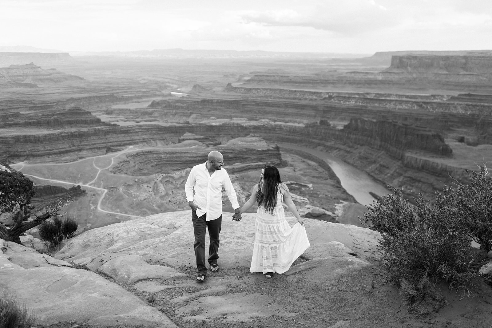 engaged couple in front of Moab desert backdrop