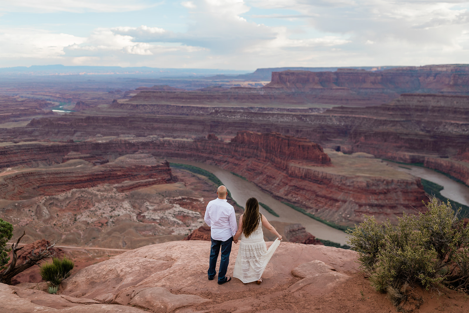 couple kisses in Moab dessert during Adventure Session with Hazel and Lace Photography