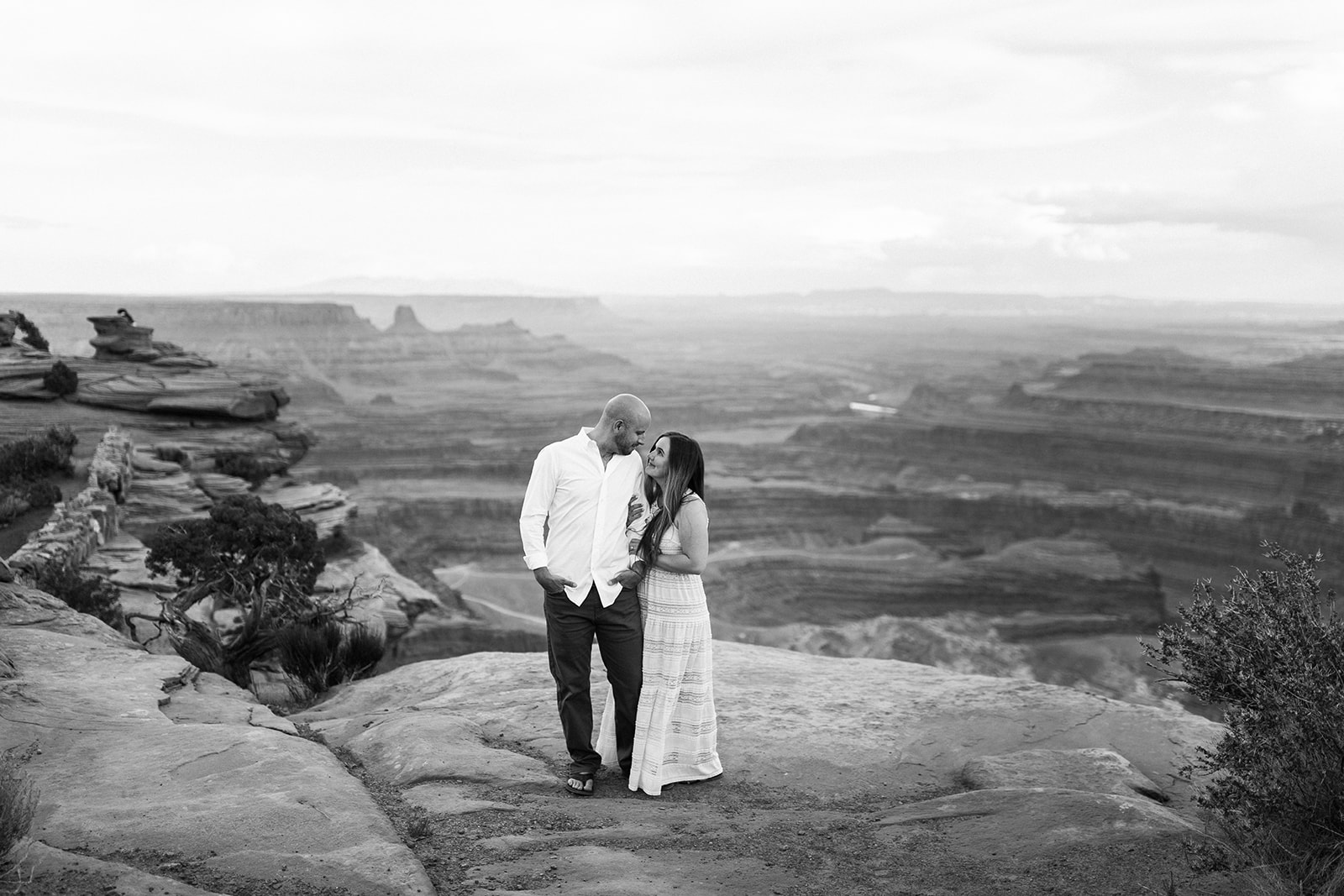 woman looks adoringly at man on top of Moab bluff