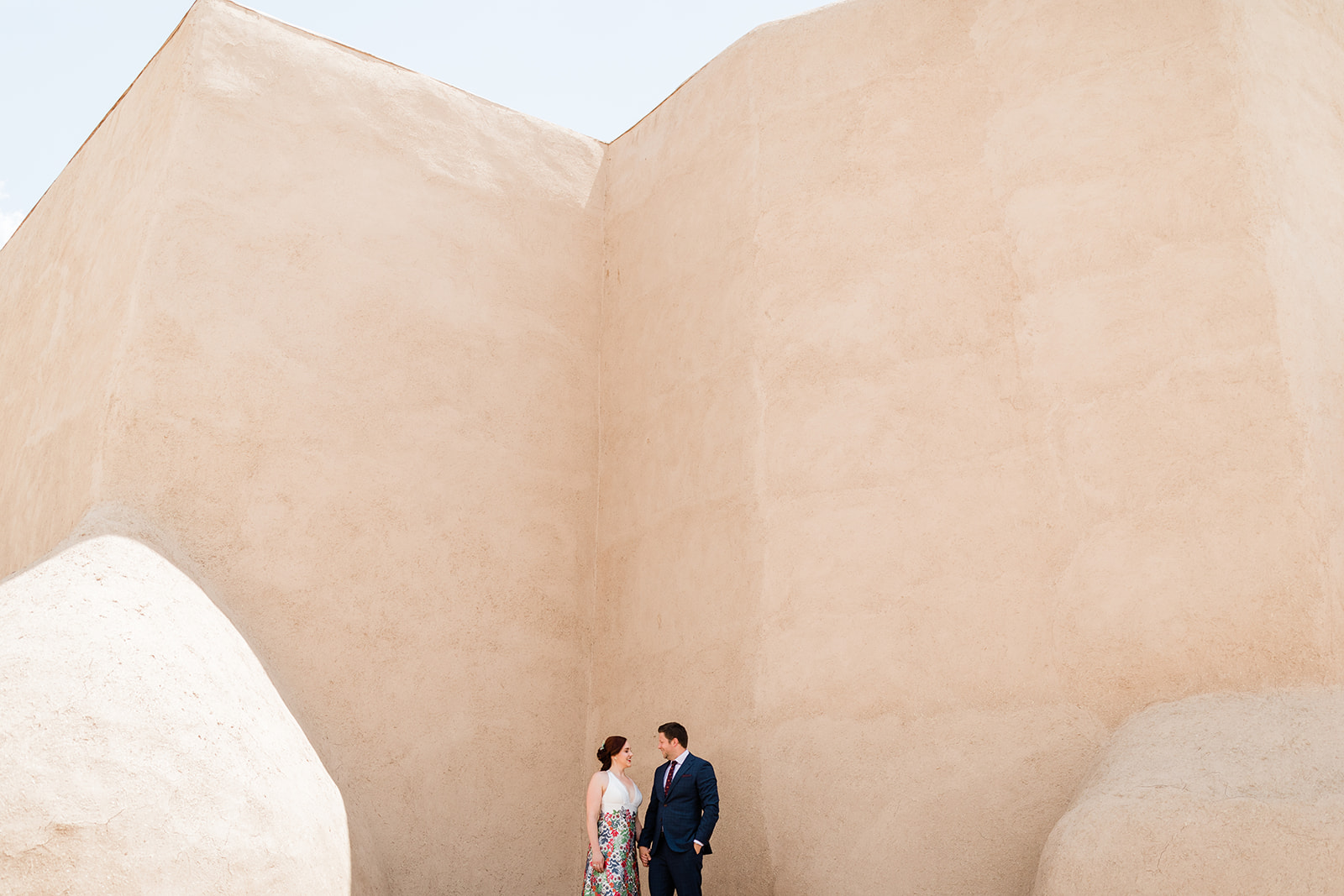 Bride and Groom portraits in front of iconic Taos New Mexico architecture