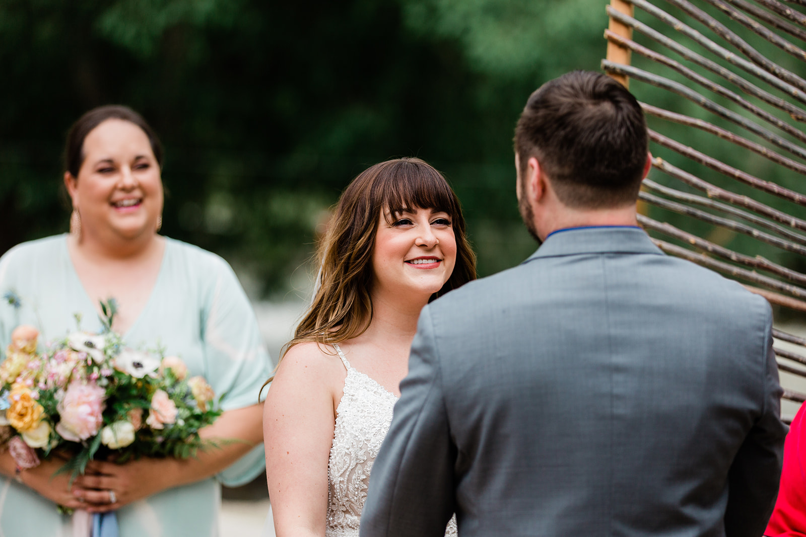 bride smiles at groom during vows