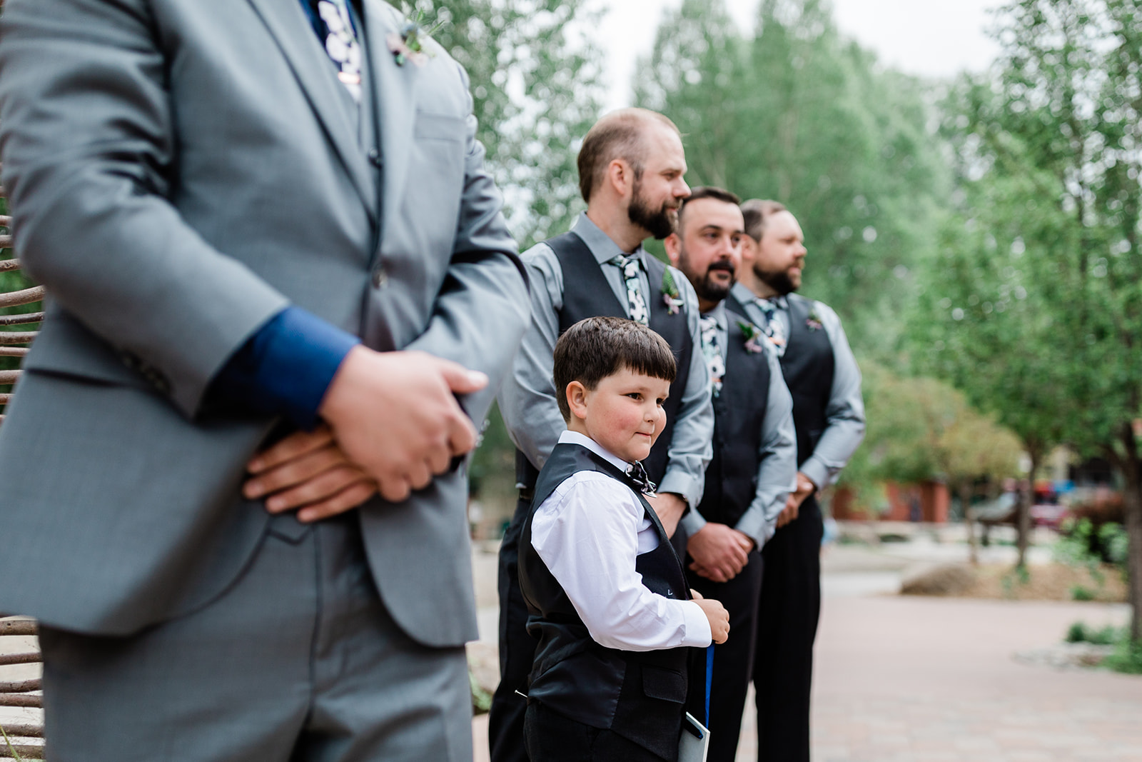 ring bearer watches processional in wedding ceremony