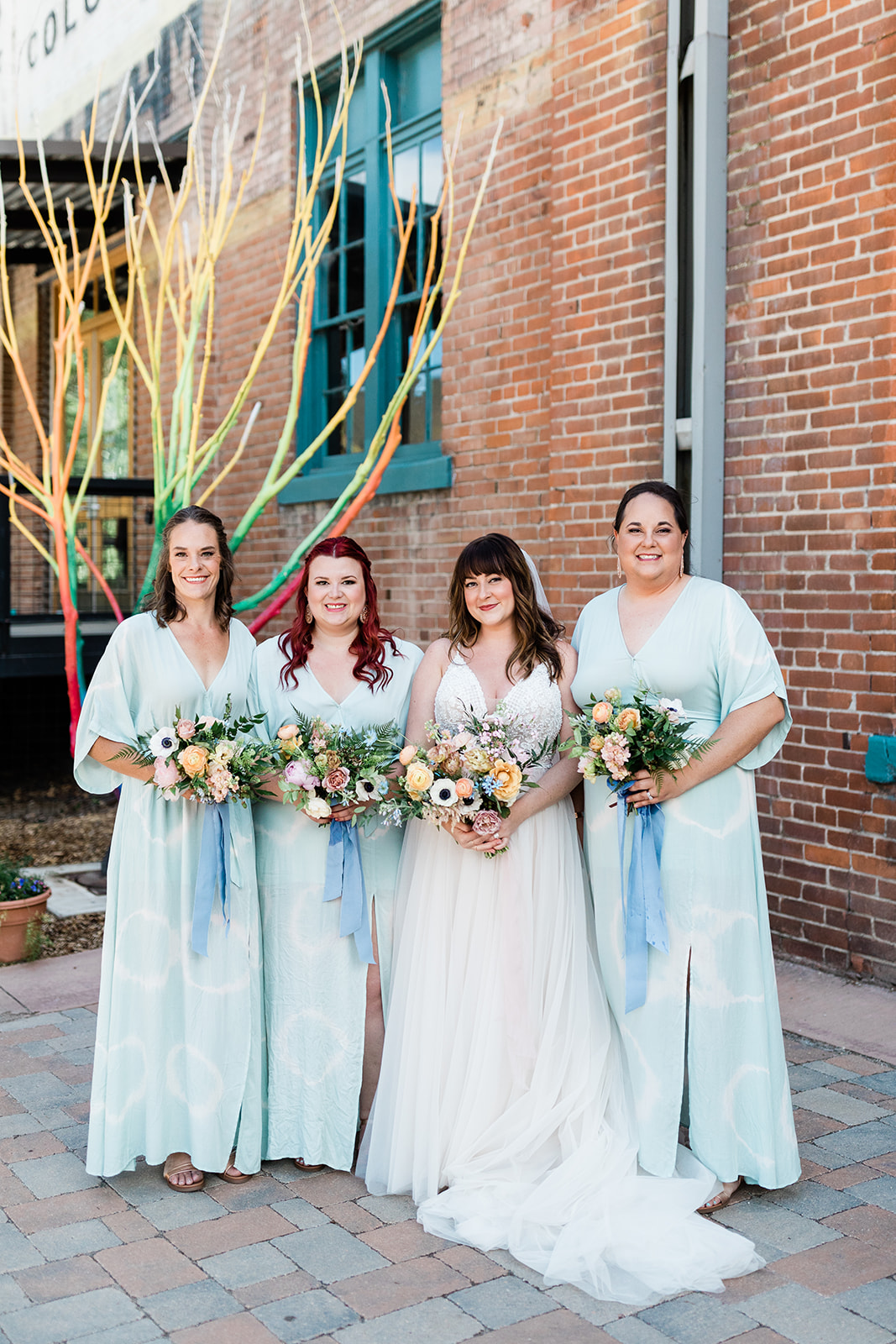 bride and bridesmaids in front of historic Salida building