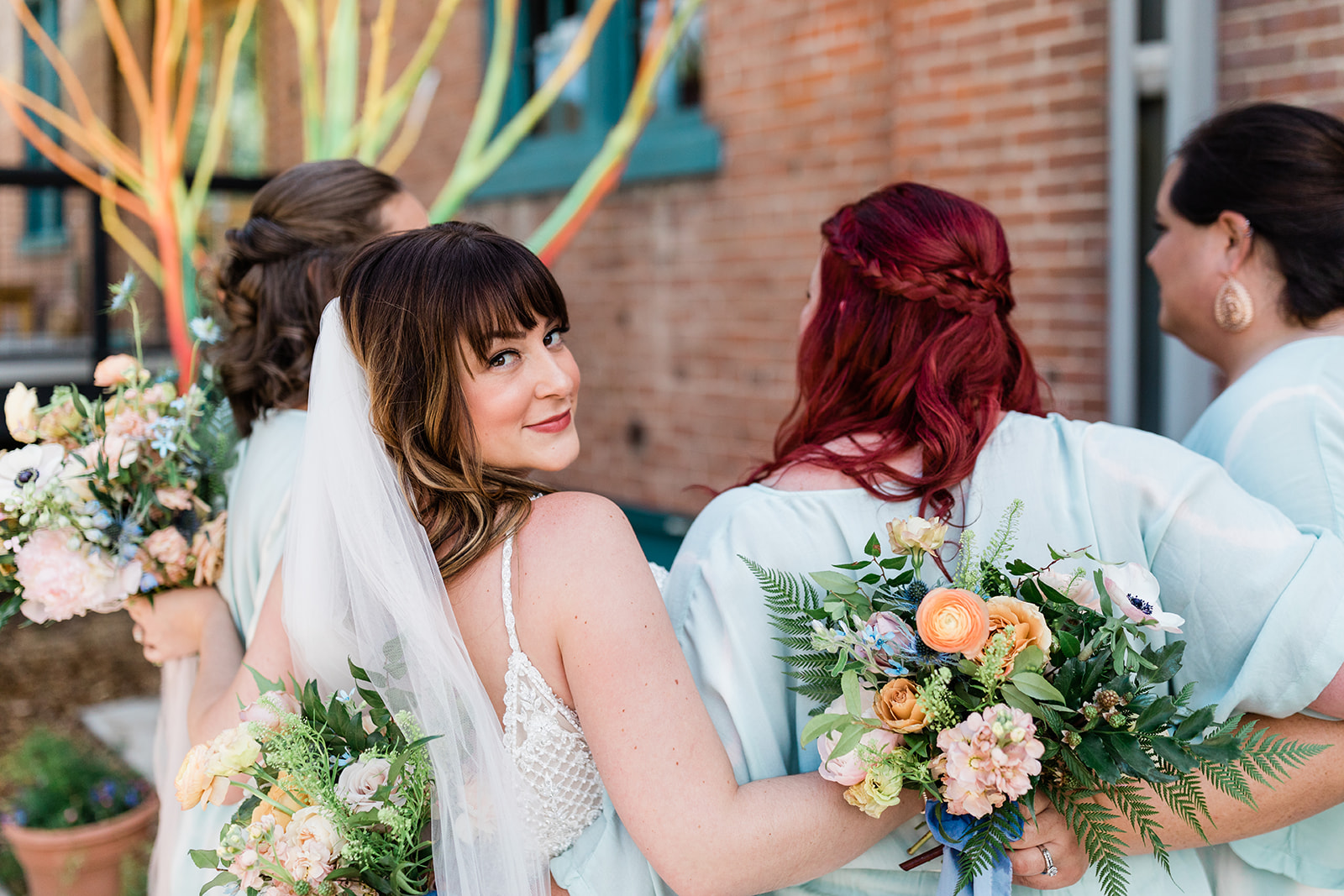 bride and bridesmaids in front of historic Salida building