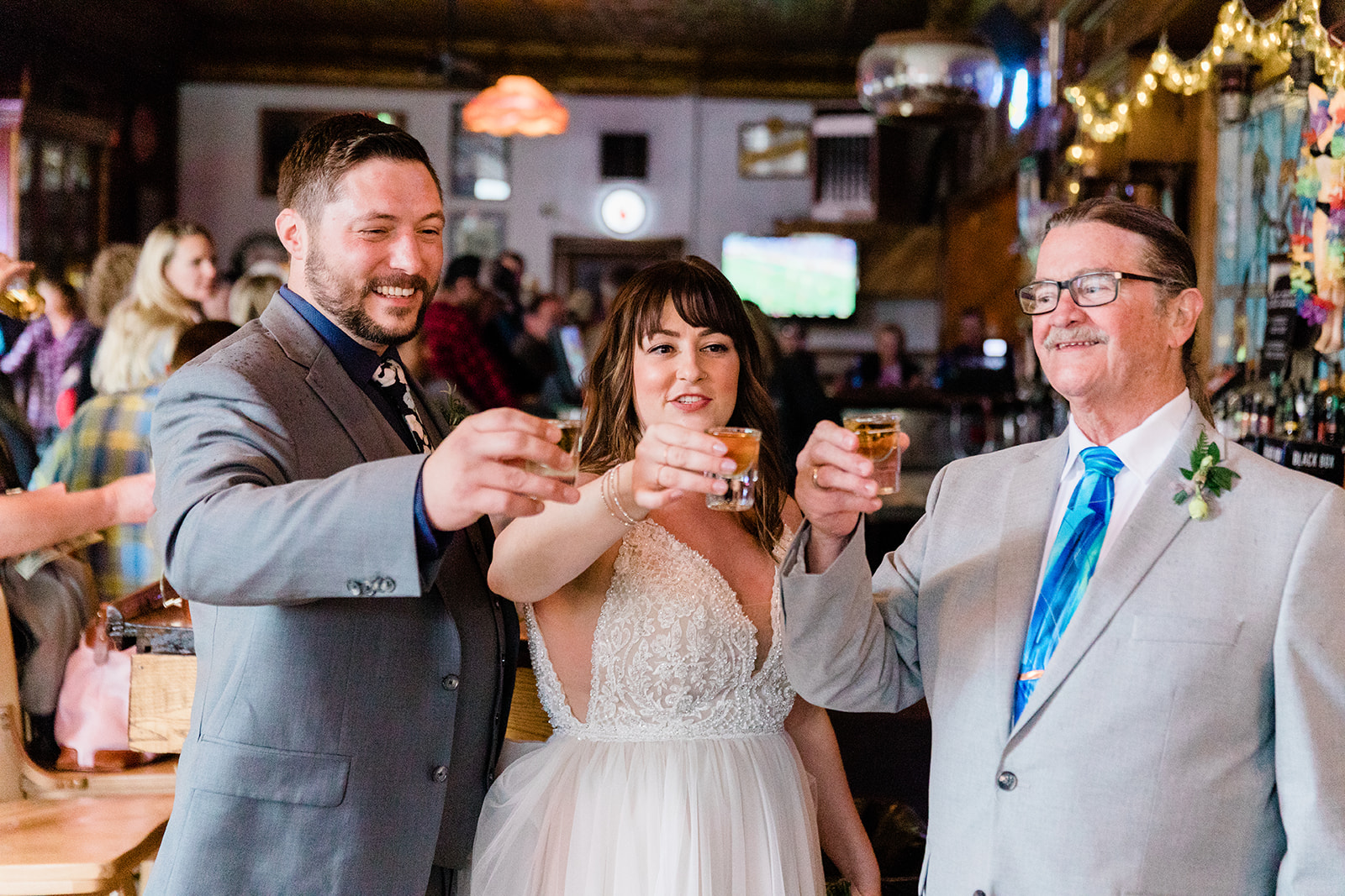 bride, groom, and guest toast