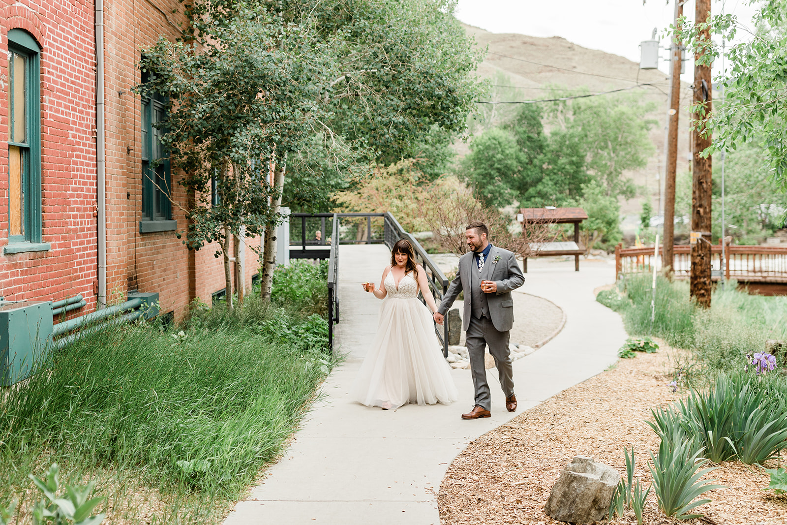 bride and groom walk to outdoor Colorado mountain wedding reception
