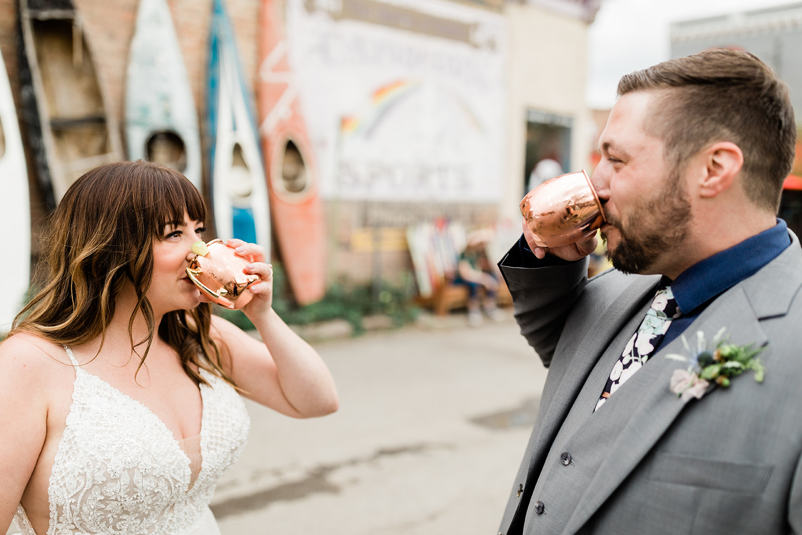 bride and groom drink moscow mules at wedding reception 