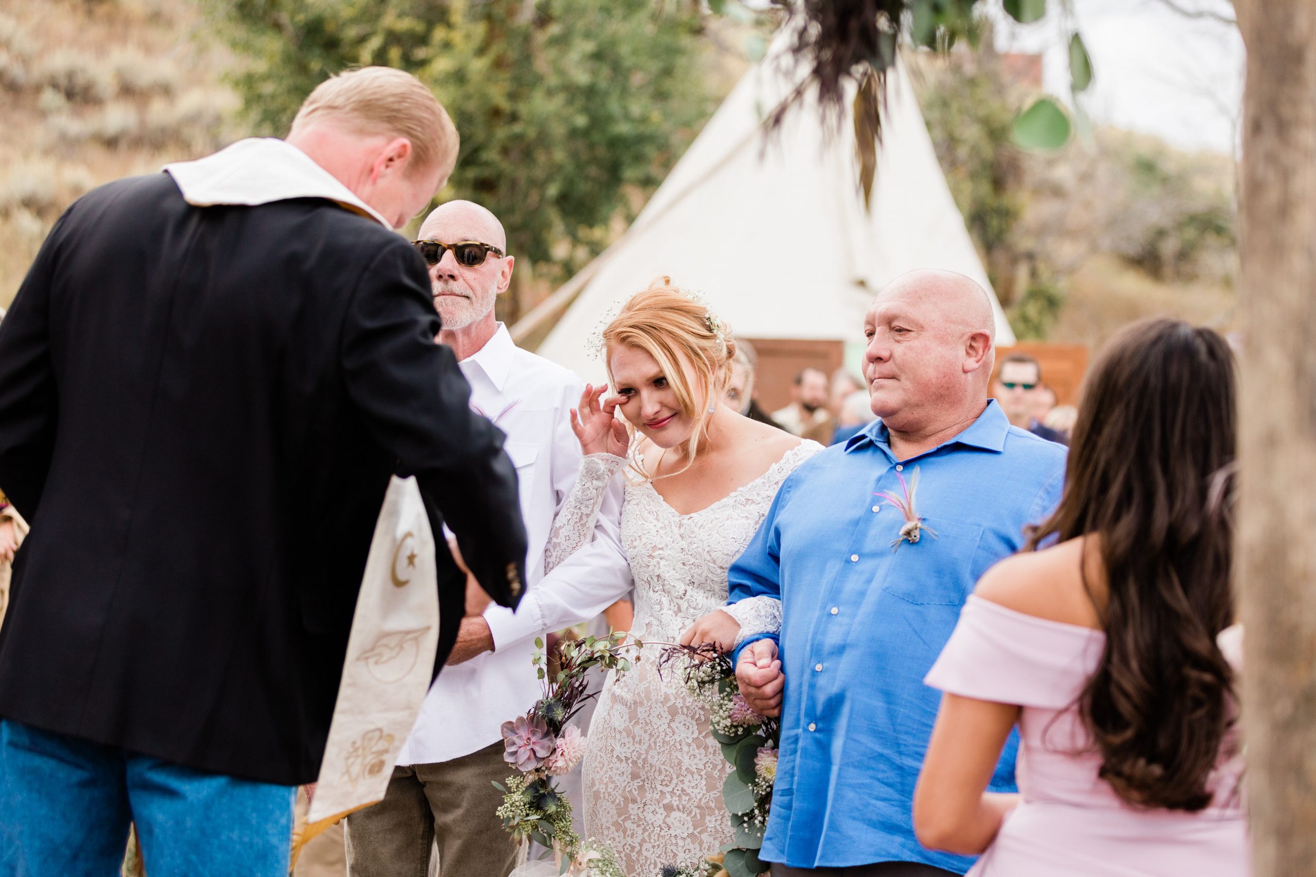 bride walks down aisle for outdoor Colorado wedding ceremony