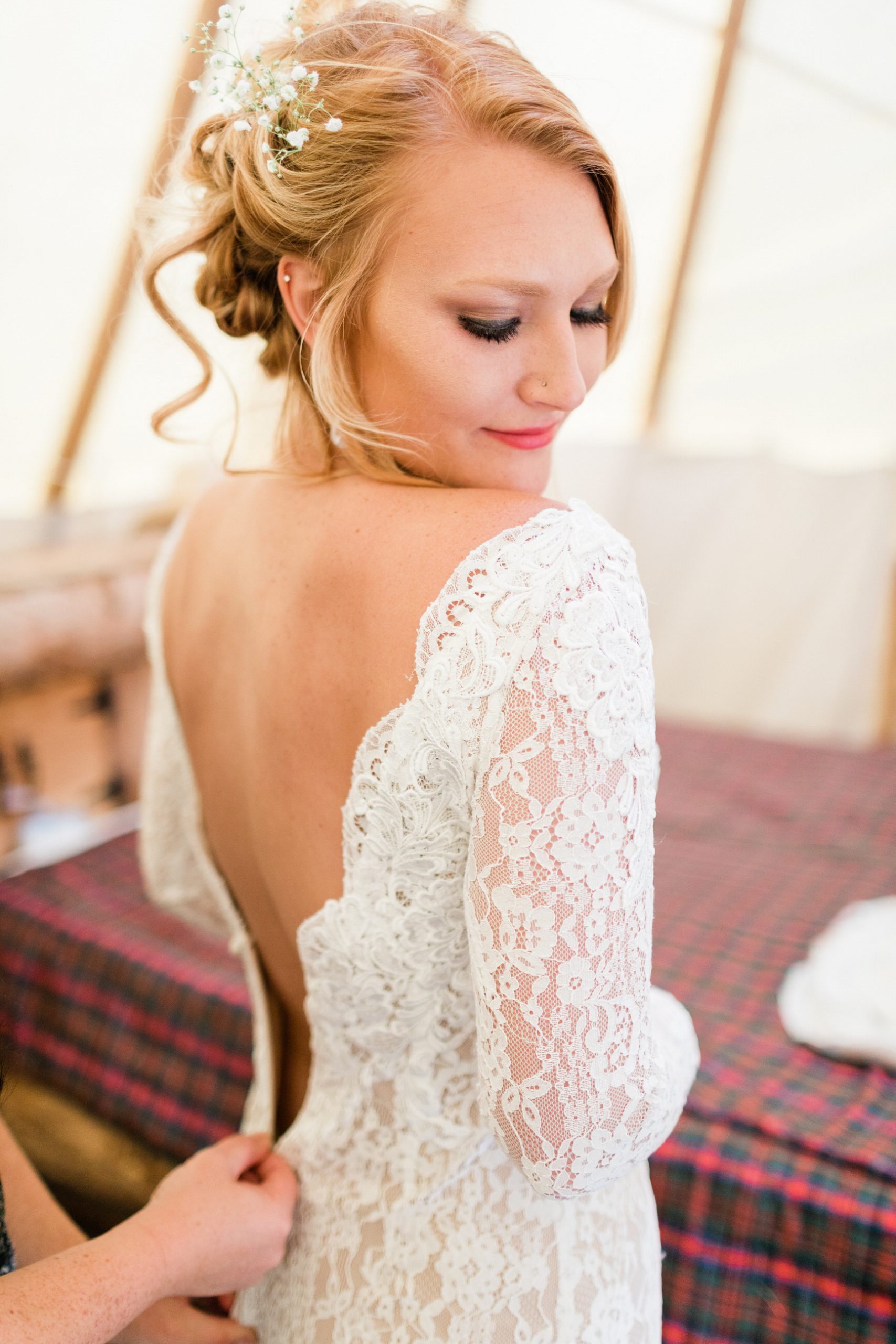 bride puts on dress before outdoor Steamboat Springs ceremony