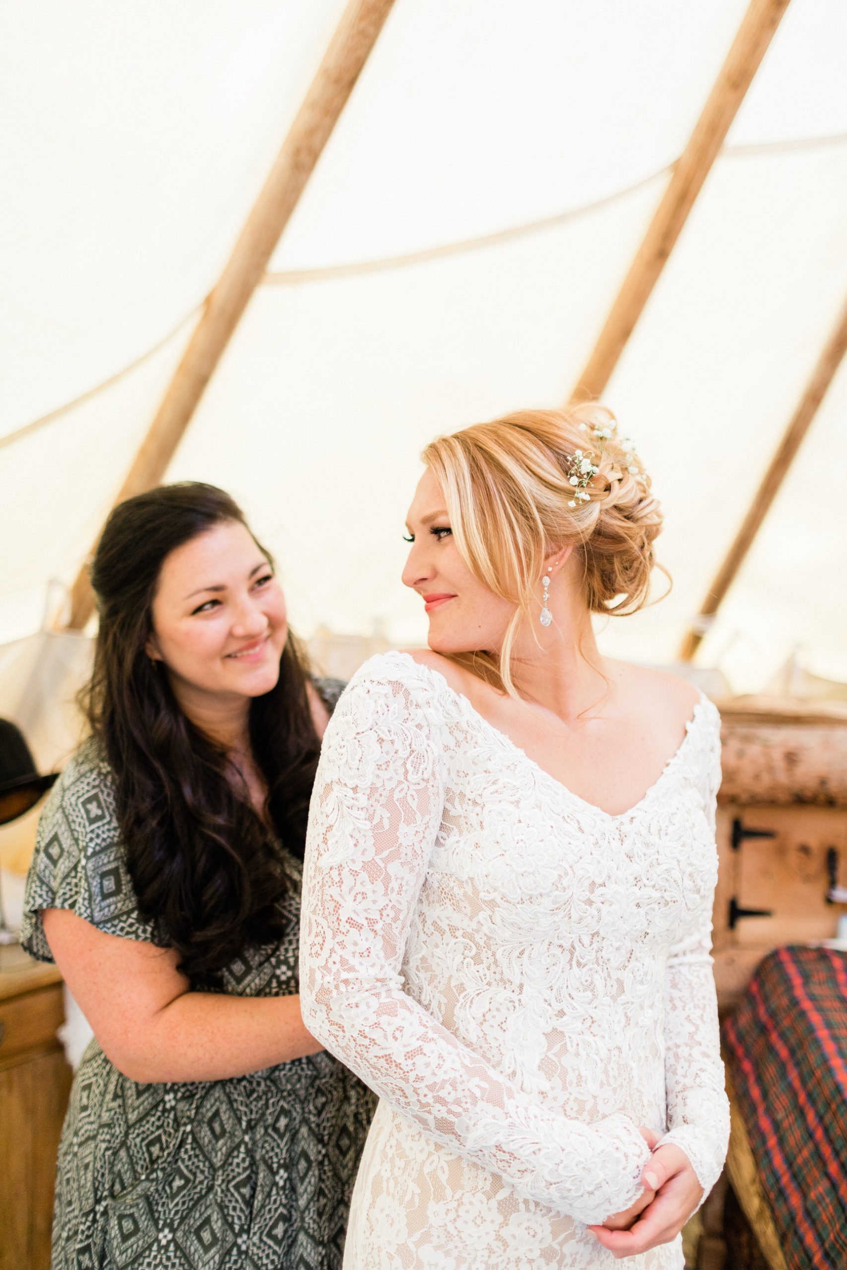 bride puts on dress before outdoor Steamboat Springs ceremony