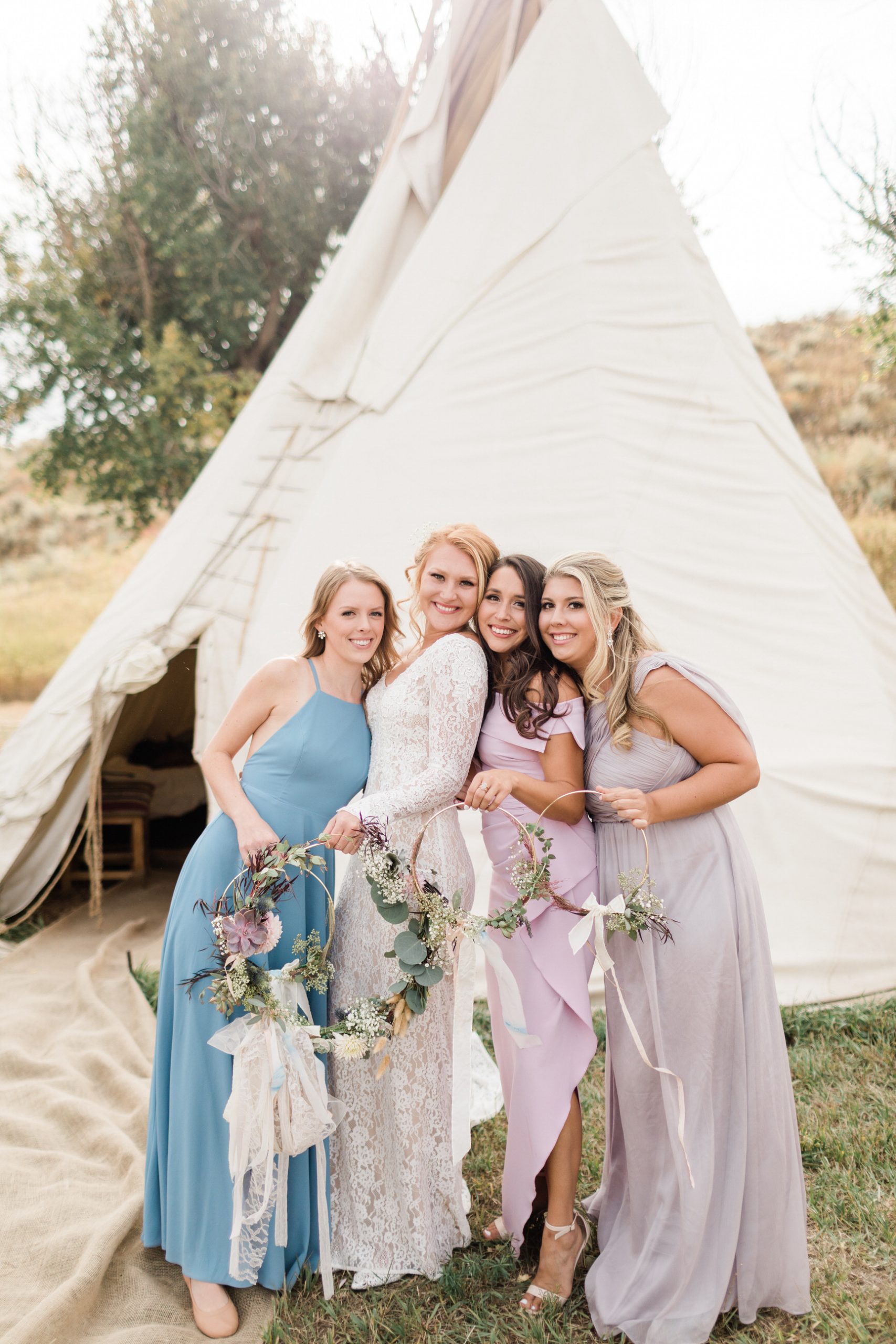 bride with bridesmaids outside luxury tent in Steamboat Springs
