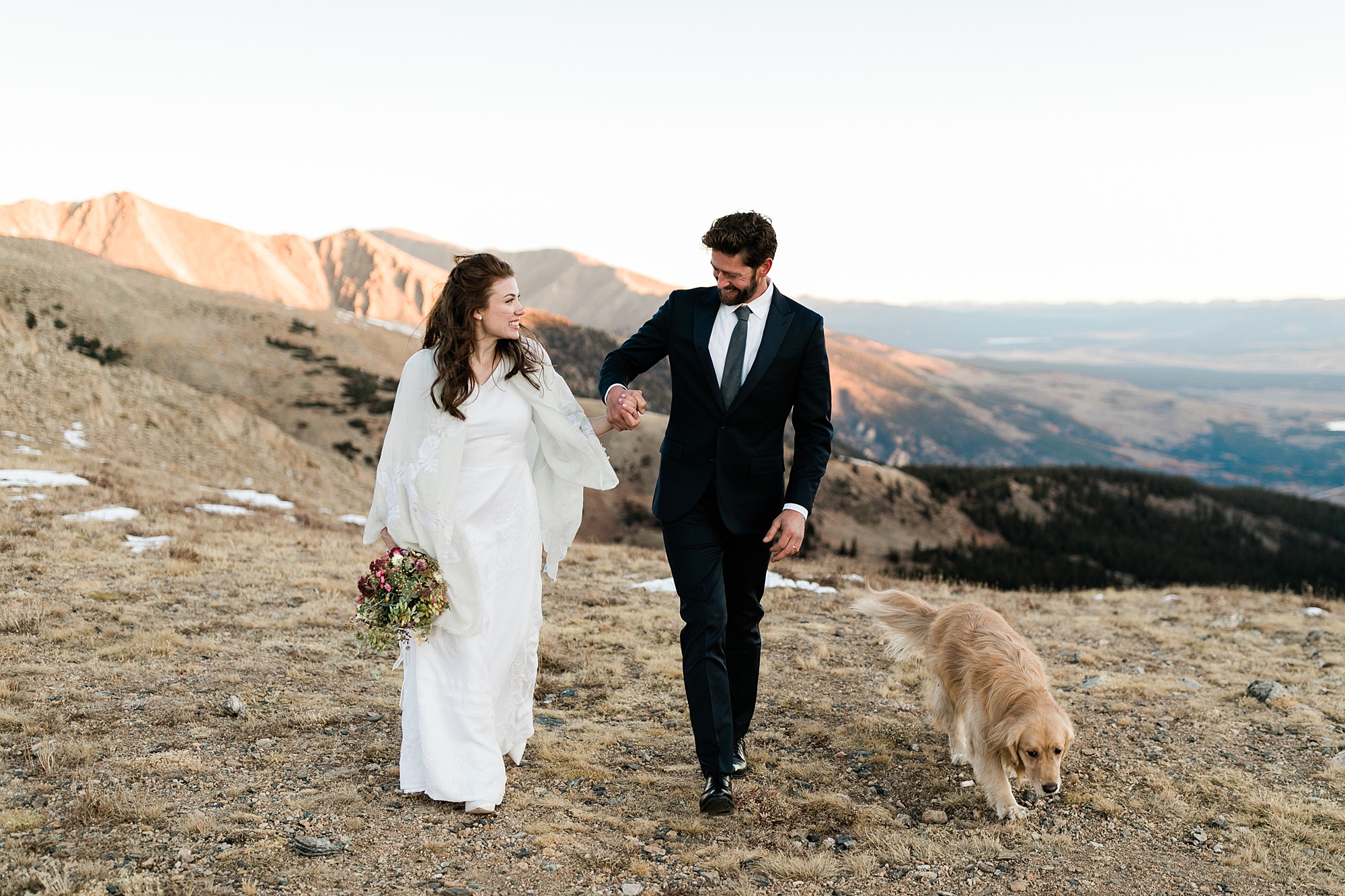 bride and groom walking with dog during elopement