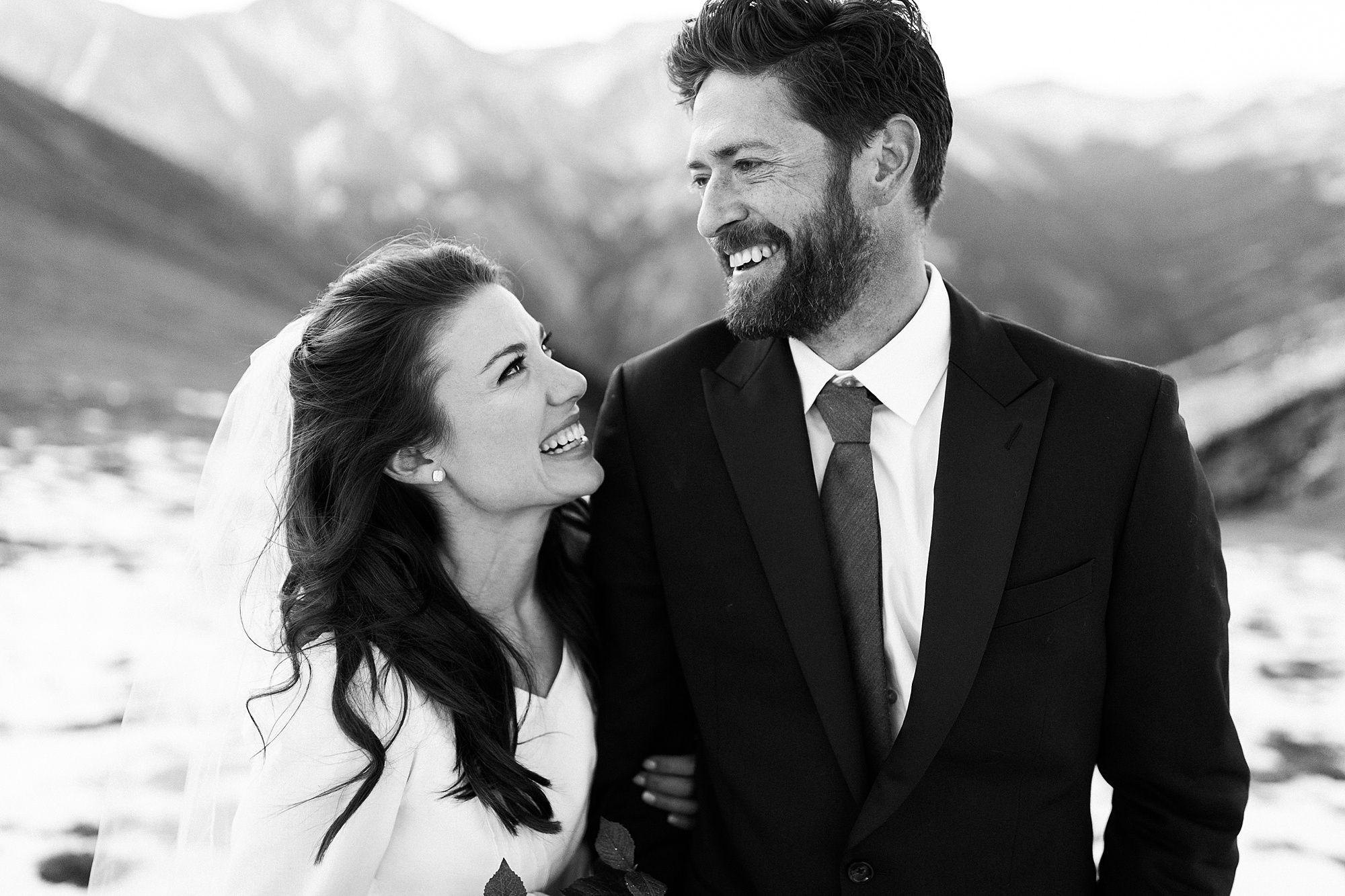 black and white portrait of bride and groom on mountain