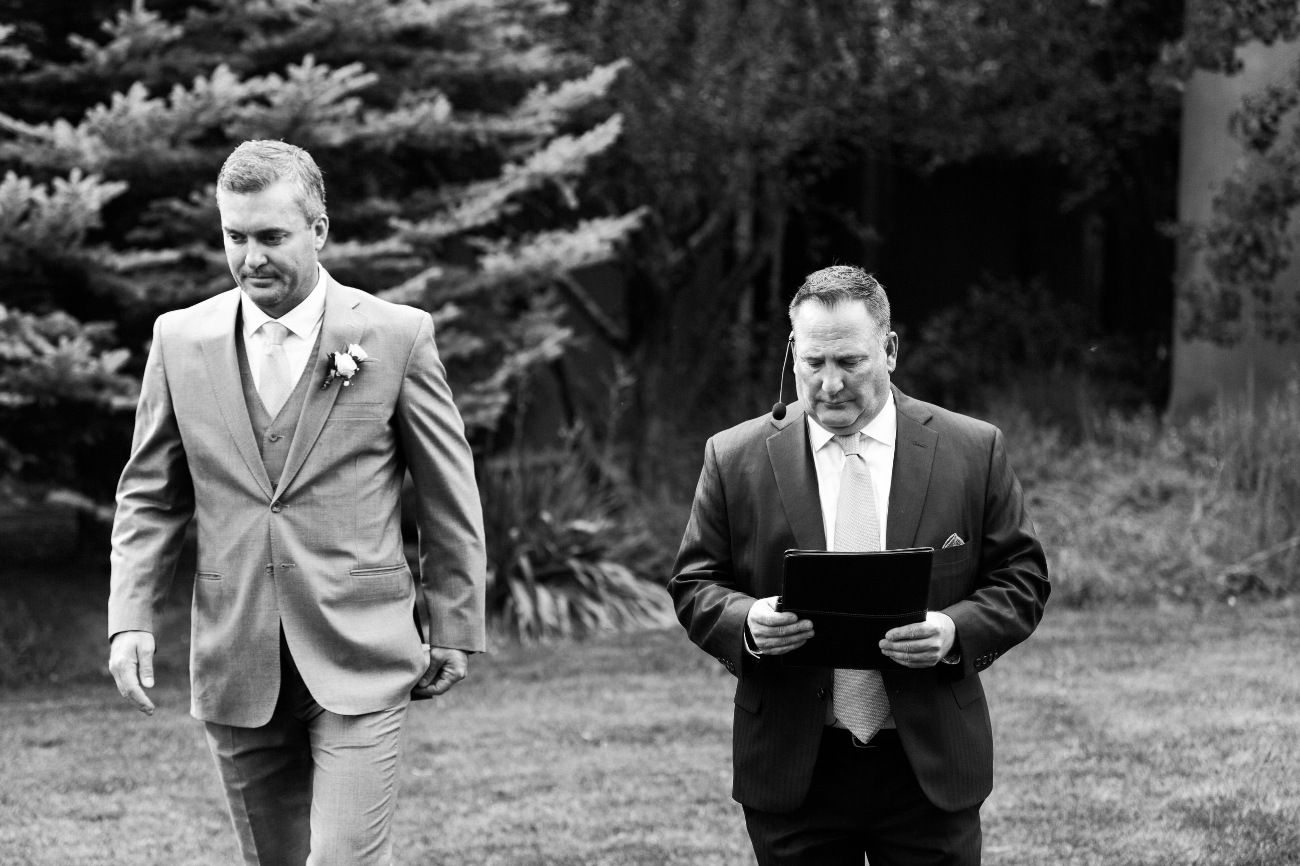 groom and officient walk to wedding ceremony