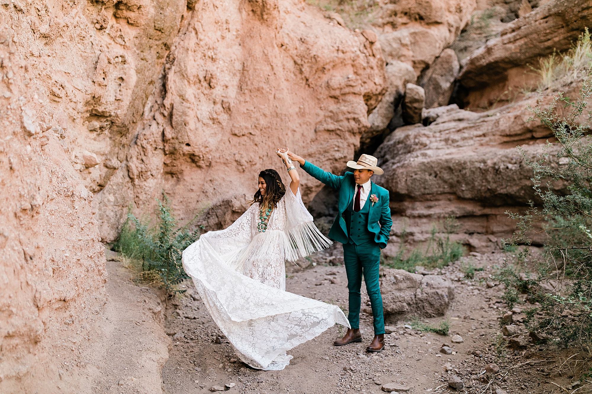 bride and groom twirl in a canyon in New Mexico