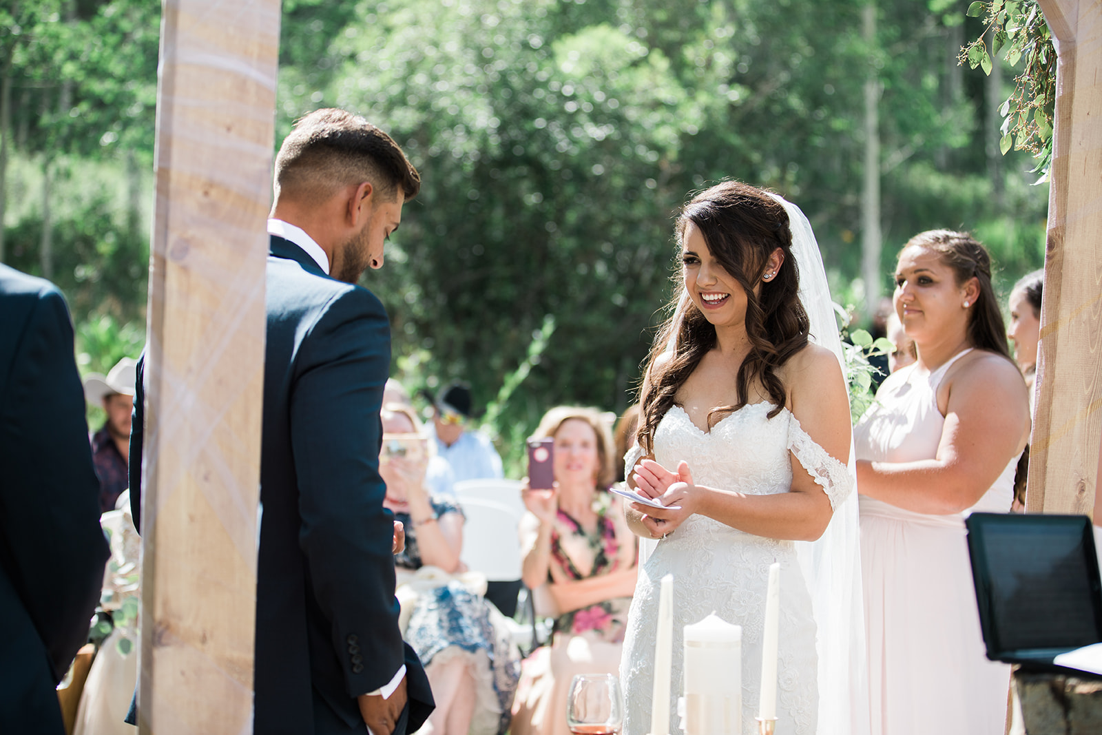 bride reads vows at outdoor Colorado wedding ceremony
