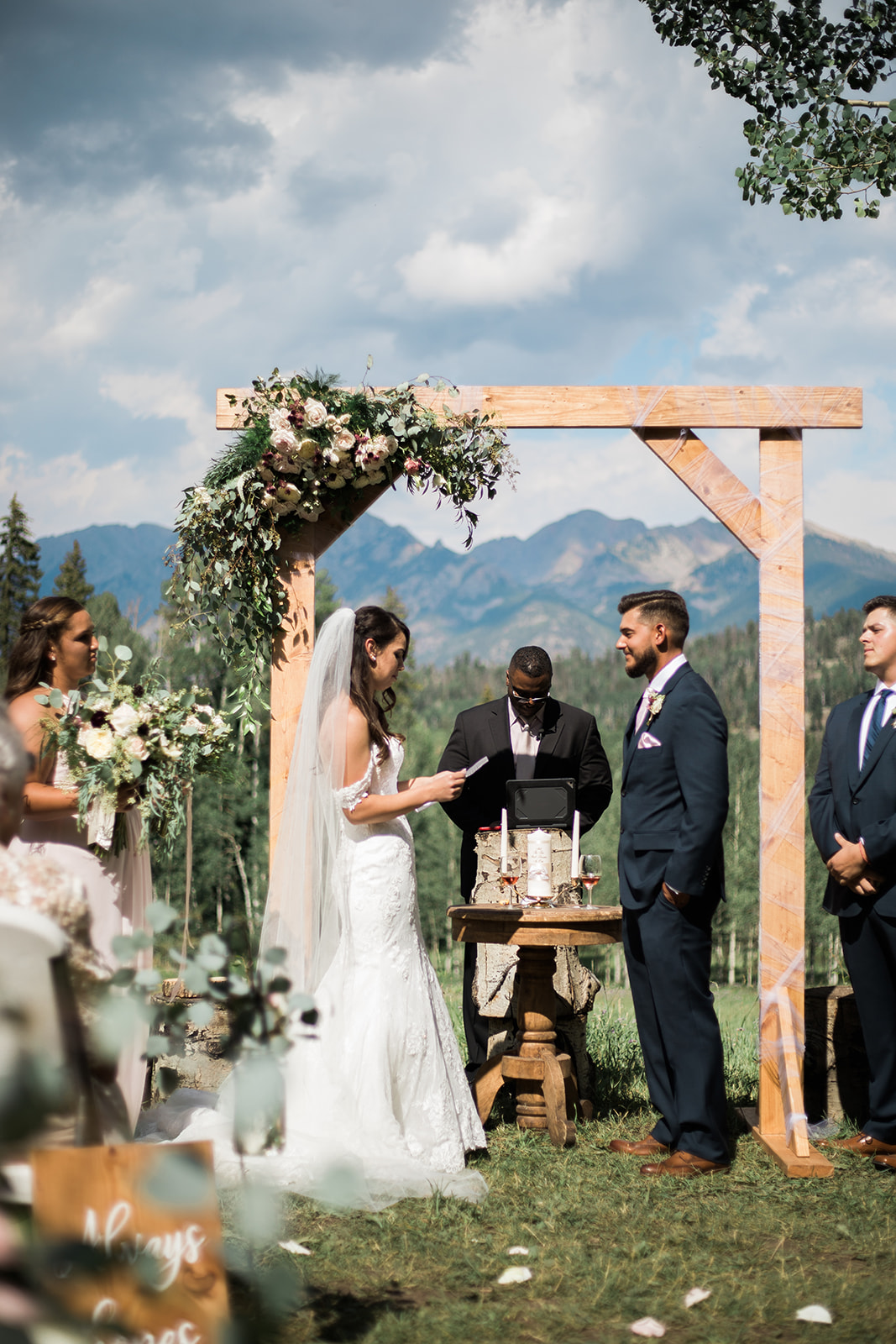 bride reads vows at outdoor Silverpick Lodge Colorado wedding ceremony
