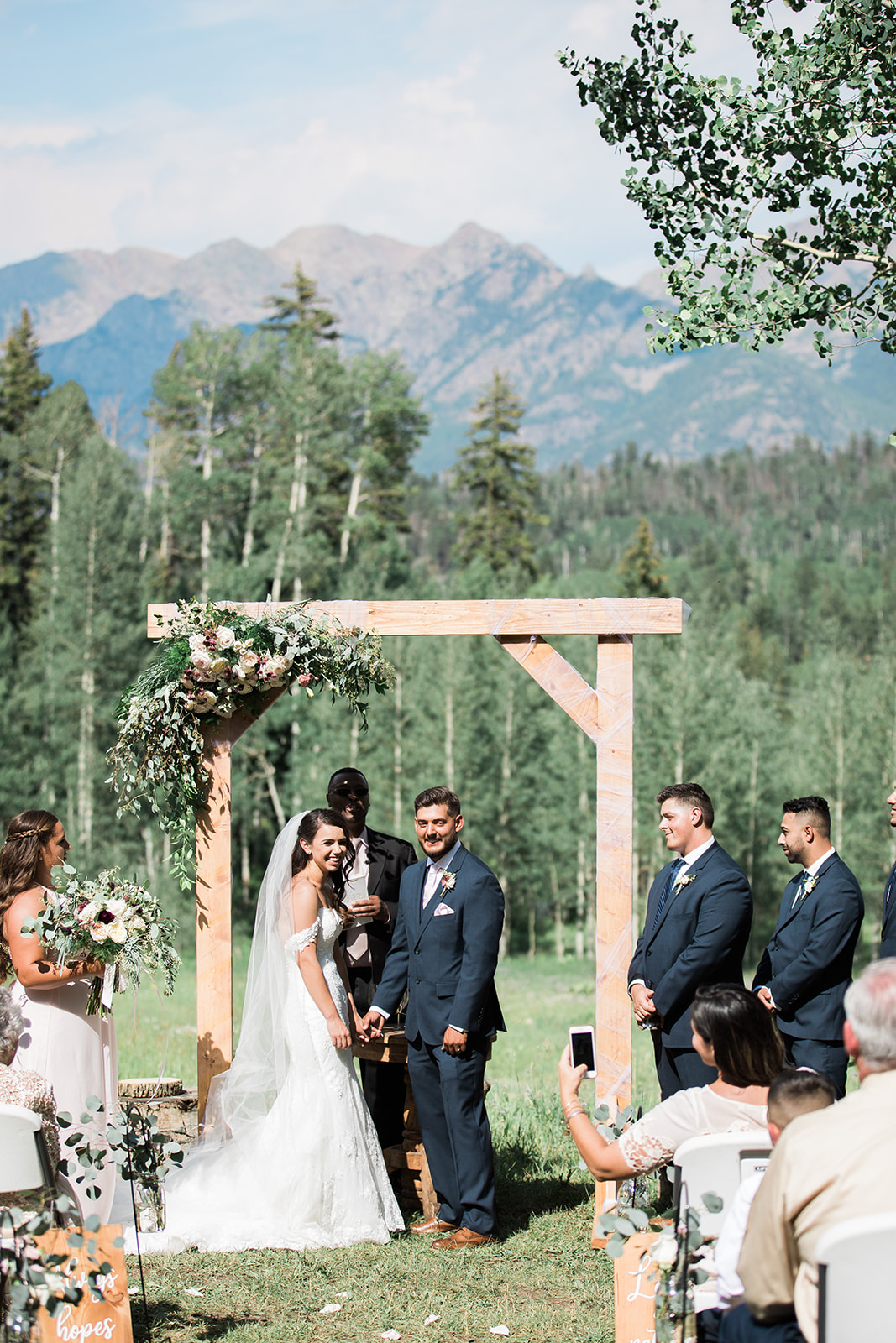 bride and groom celebrate getting married in a Silverpick Lodge Colorado mountain field