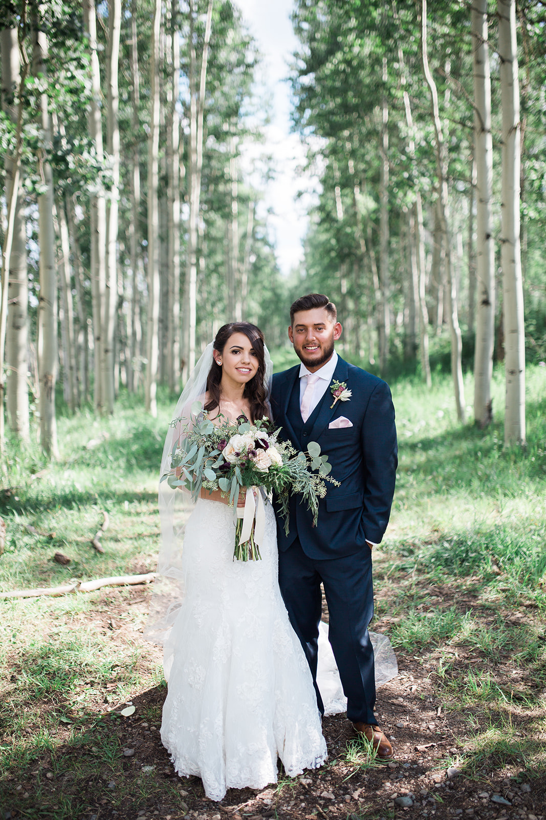 bride and groom pose for portrait in aspen grove