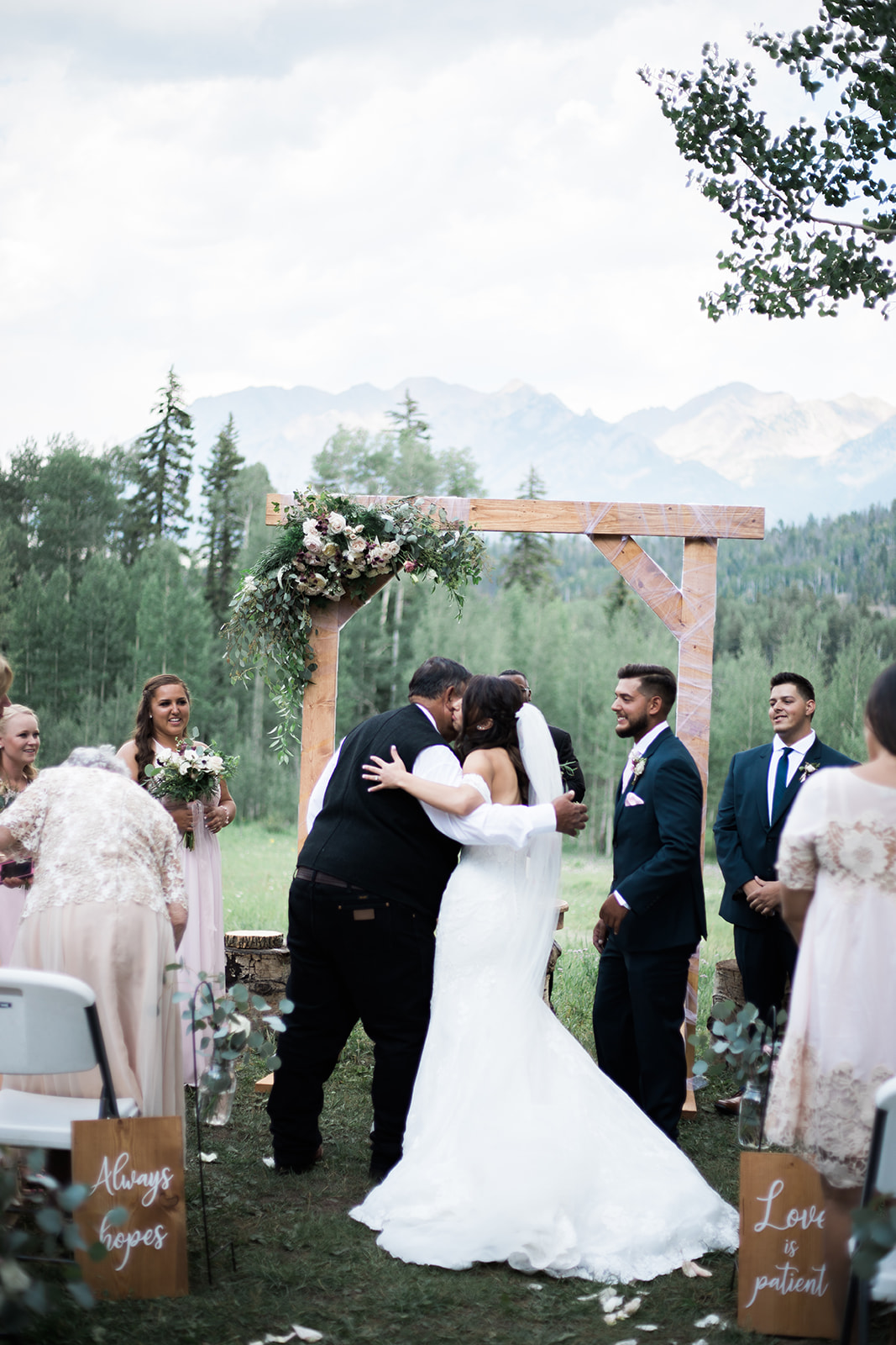 bride and father hug at alter at Silverpick Lodge outdoor wedding