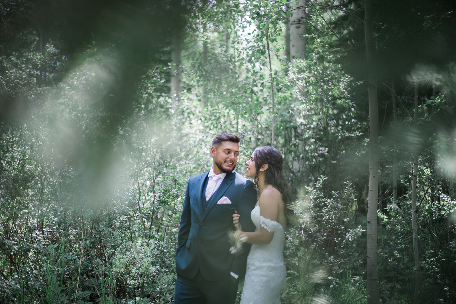 bride and groom standing in woods at Silverpick Lodge