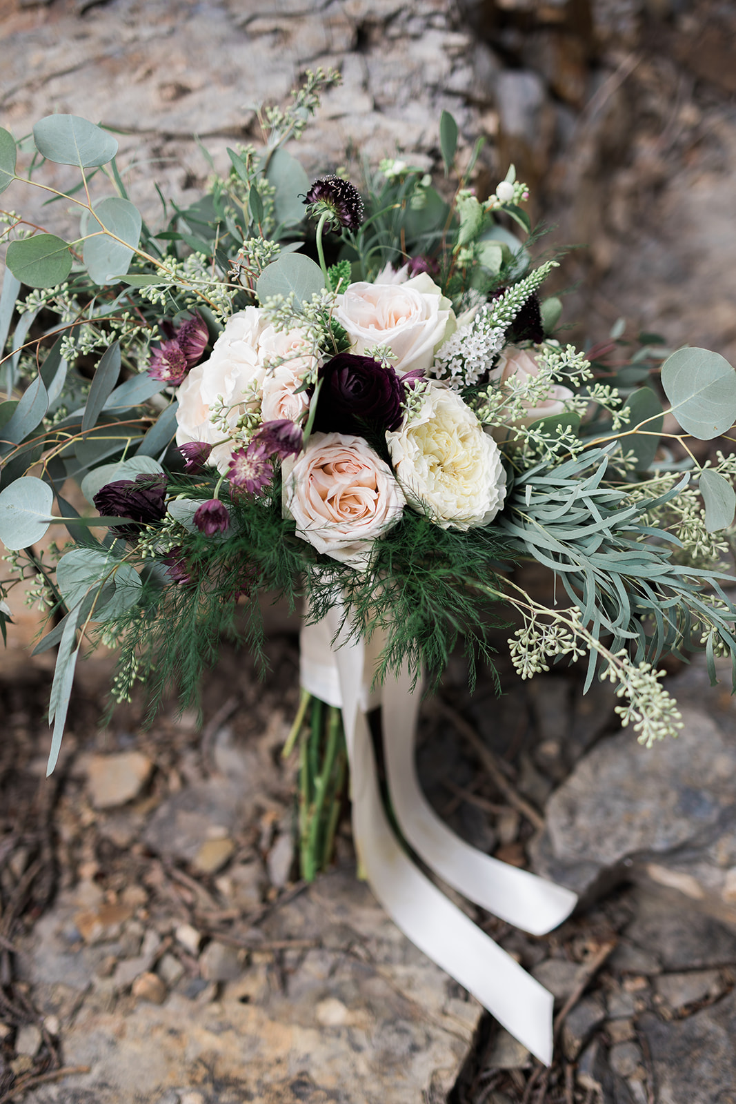 bride's bouquet in woods outside of Silverpick Lodge Durango Colorado