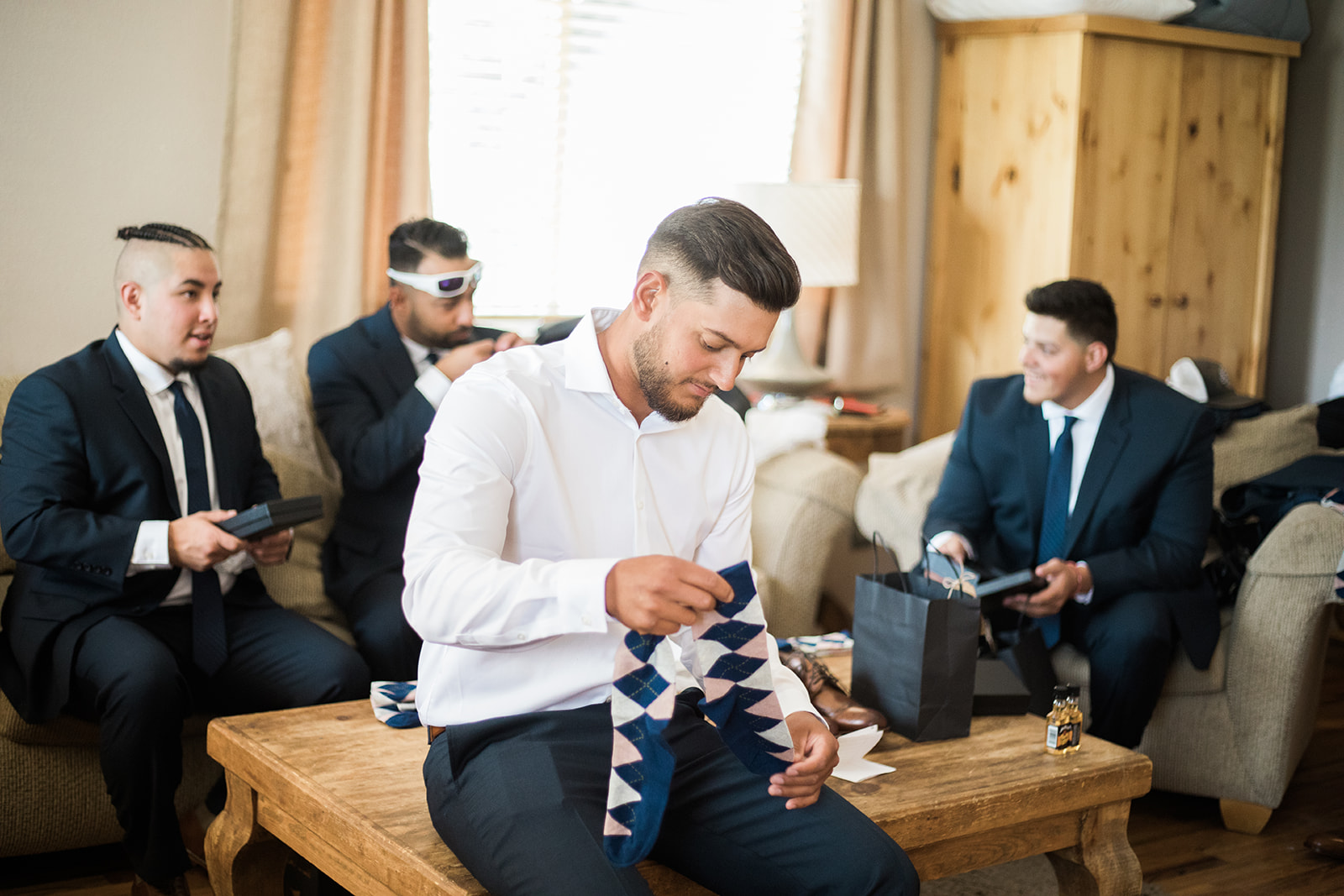 groom holding up socks at Silverpick Lodge
