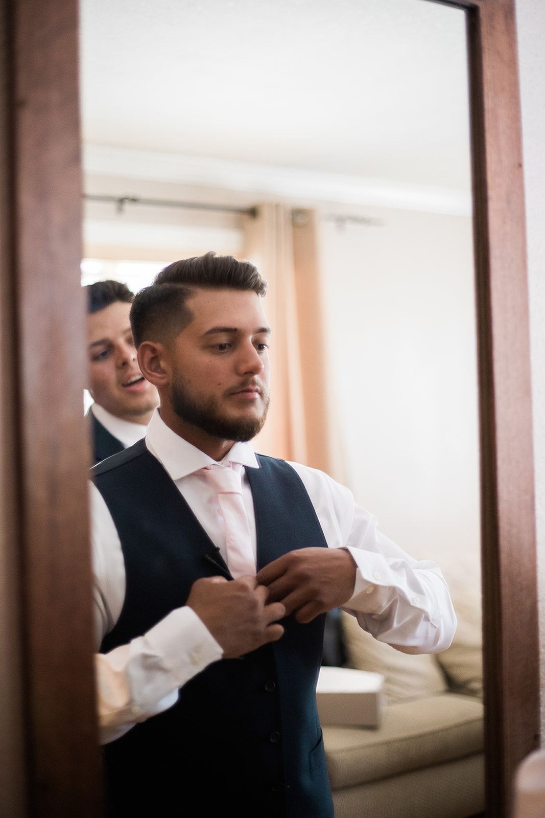 groom buttoning vest for Silverpick Lodge wedding