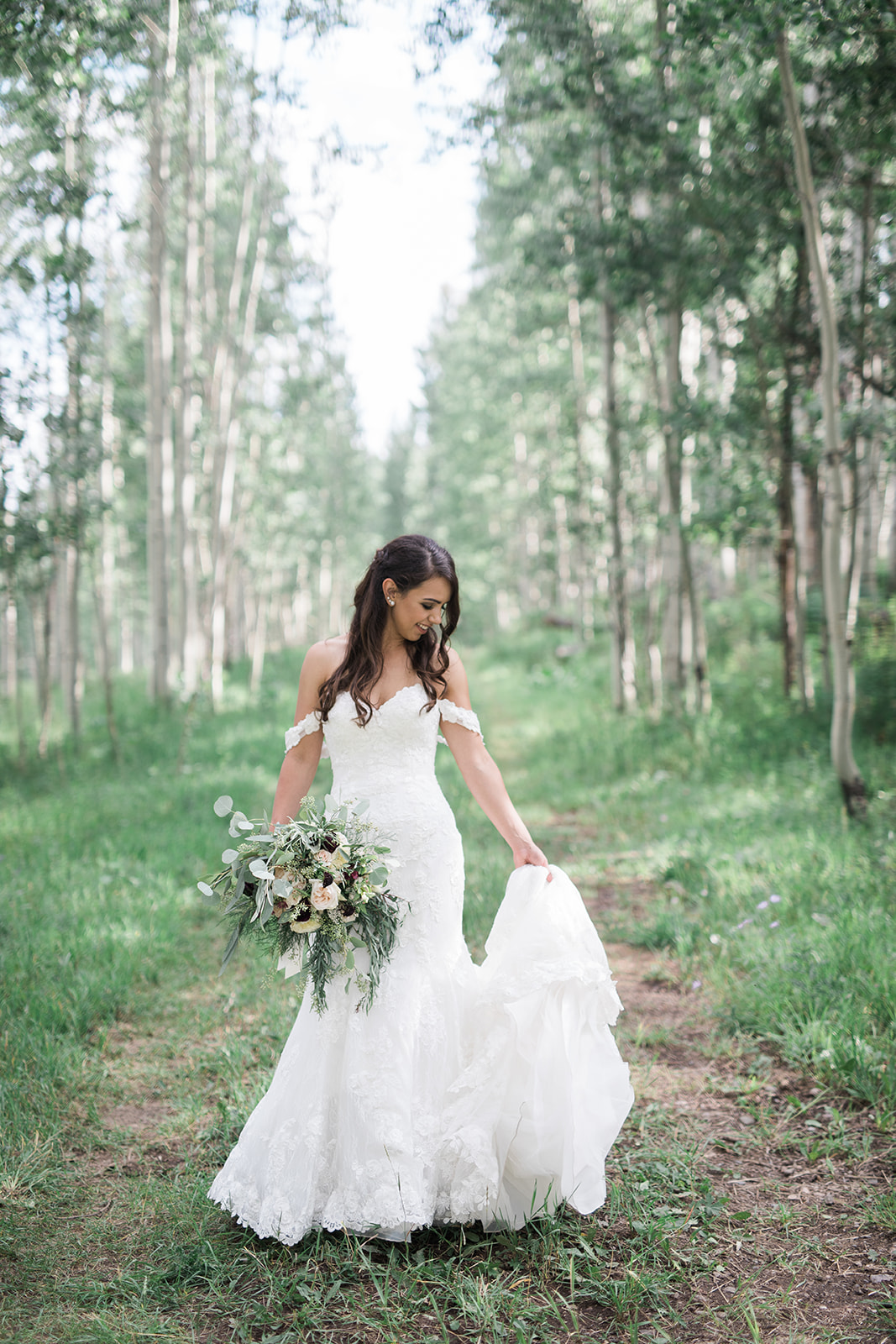 bride spins in wedding dress in Durango aspen grove