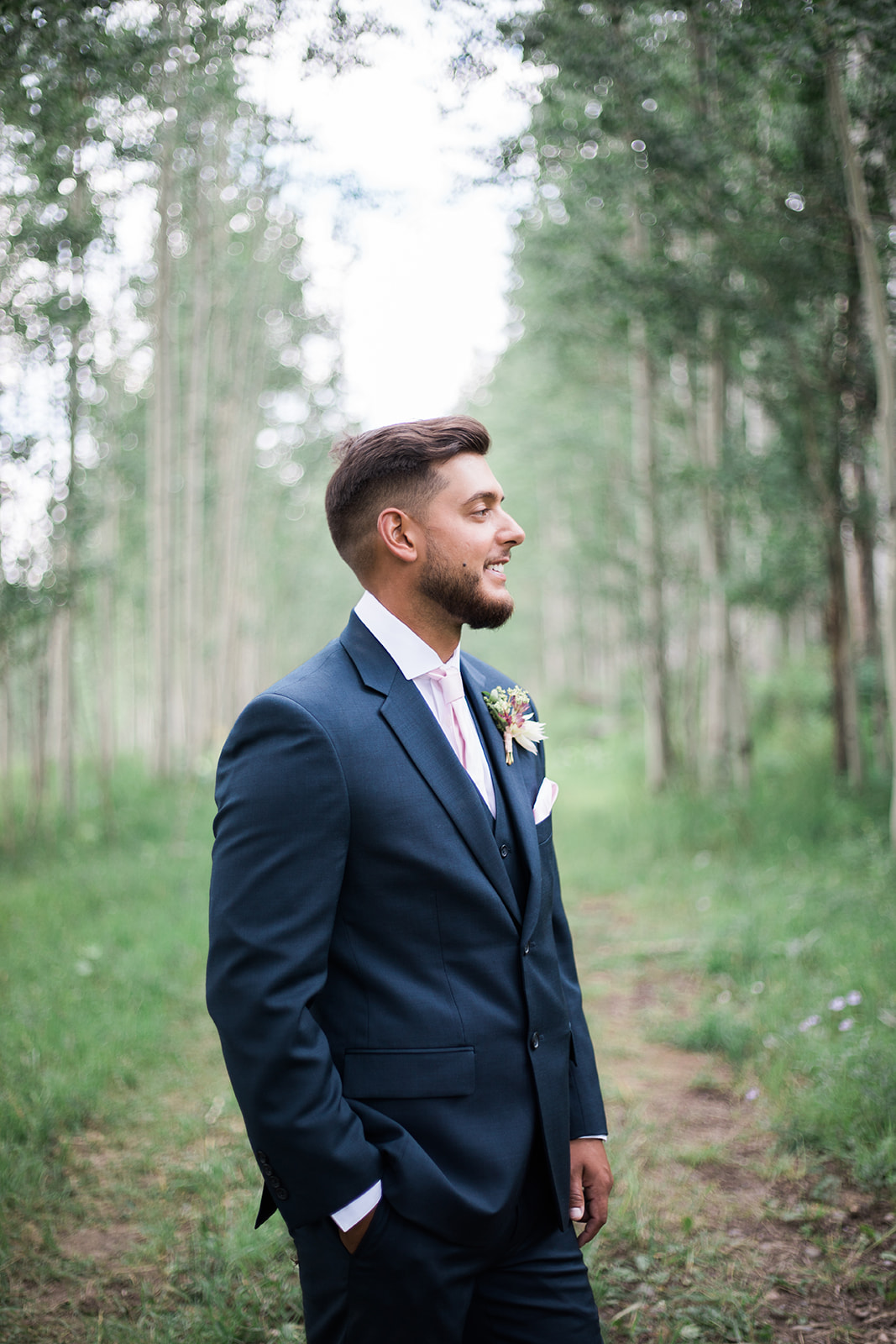 groom standing in Colorado Durango woods