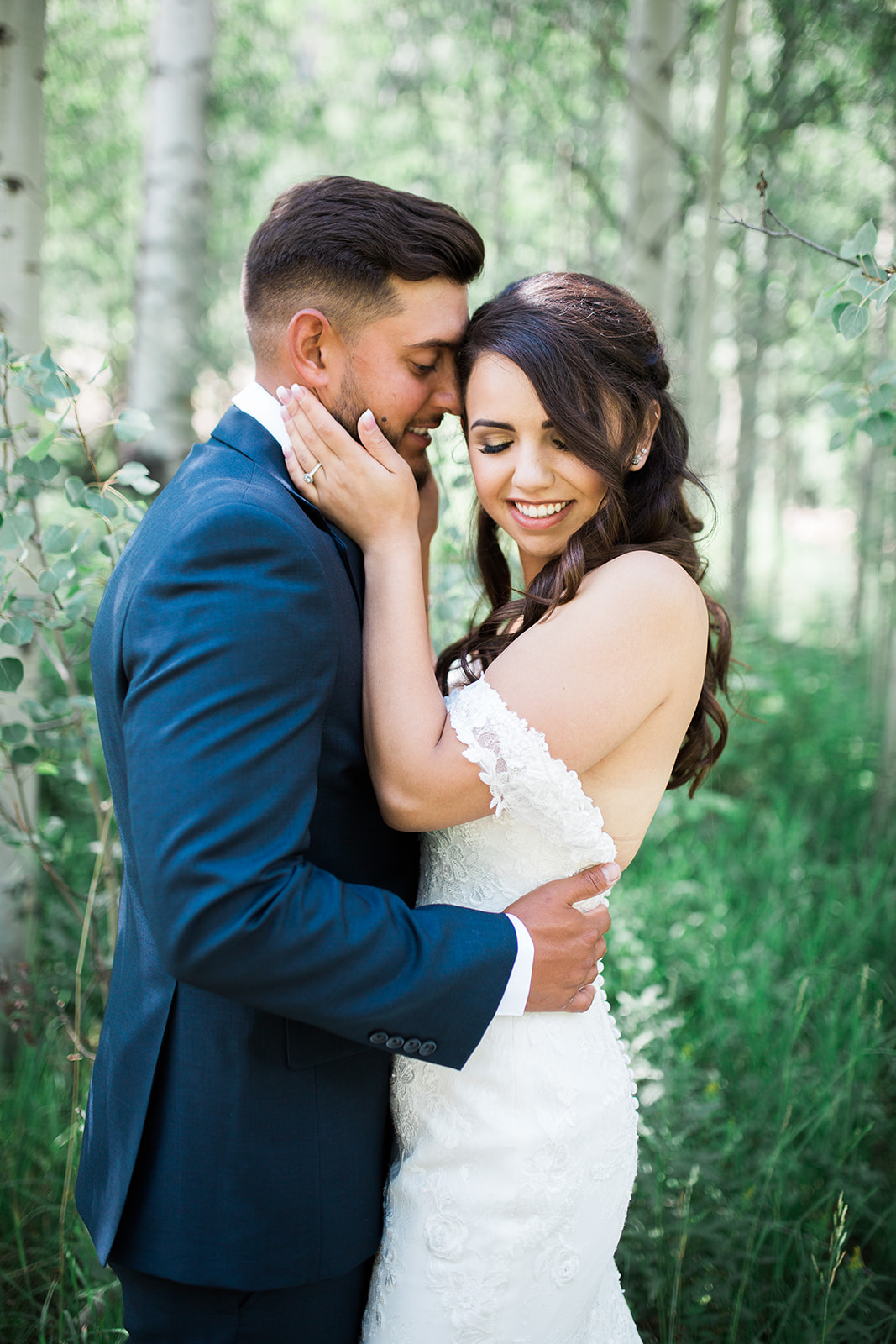 groom looks at bride for first time in Colorado woods