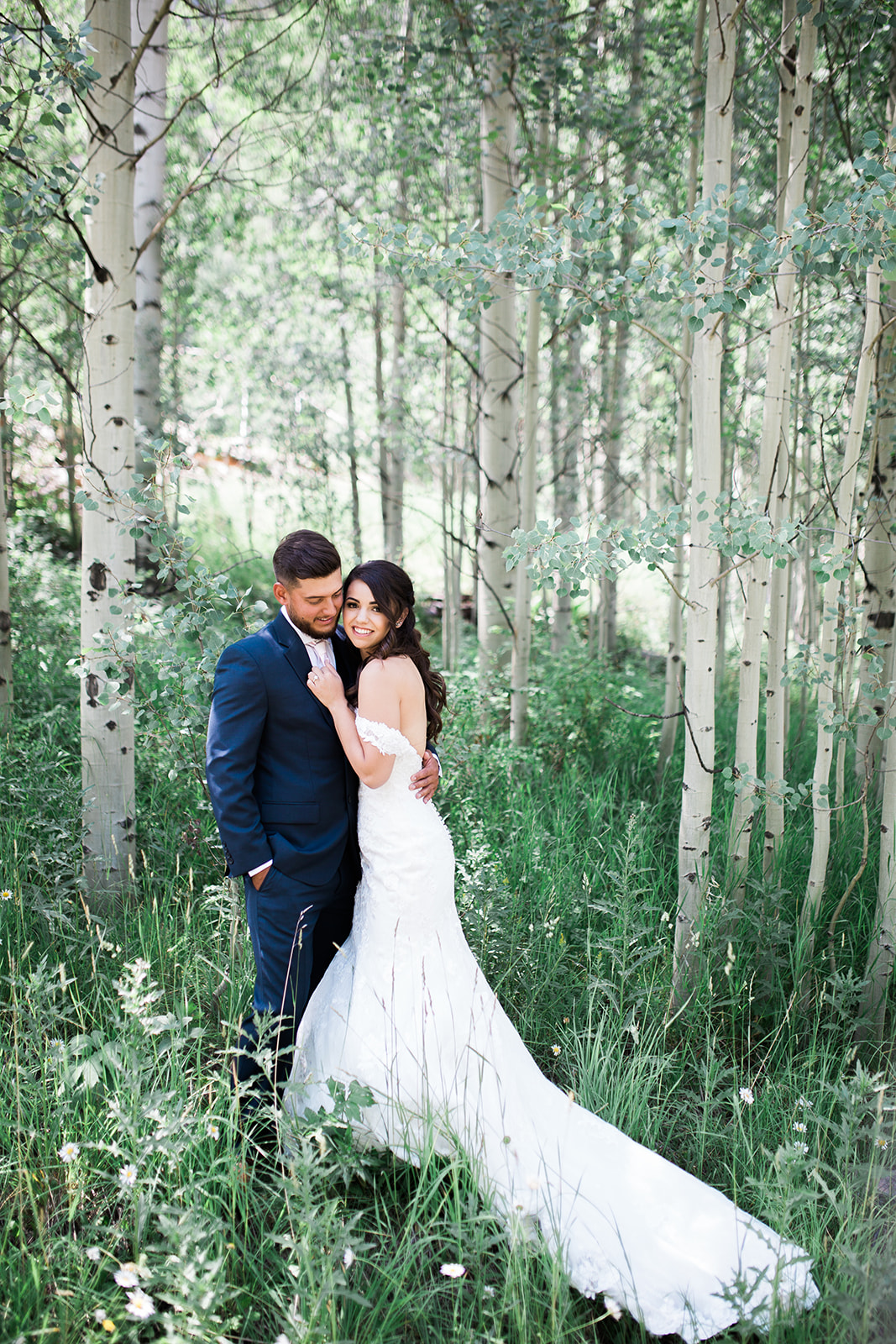 bride and groom in green aspen grove in Durango Colorado