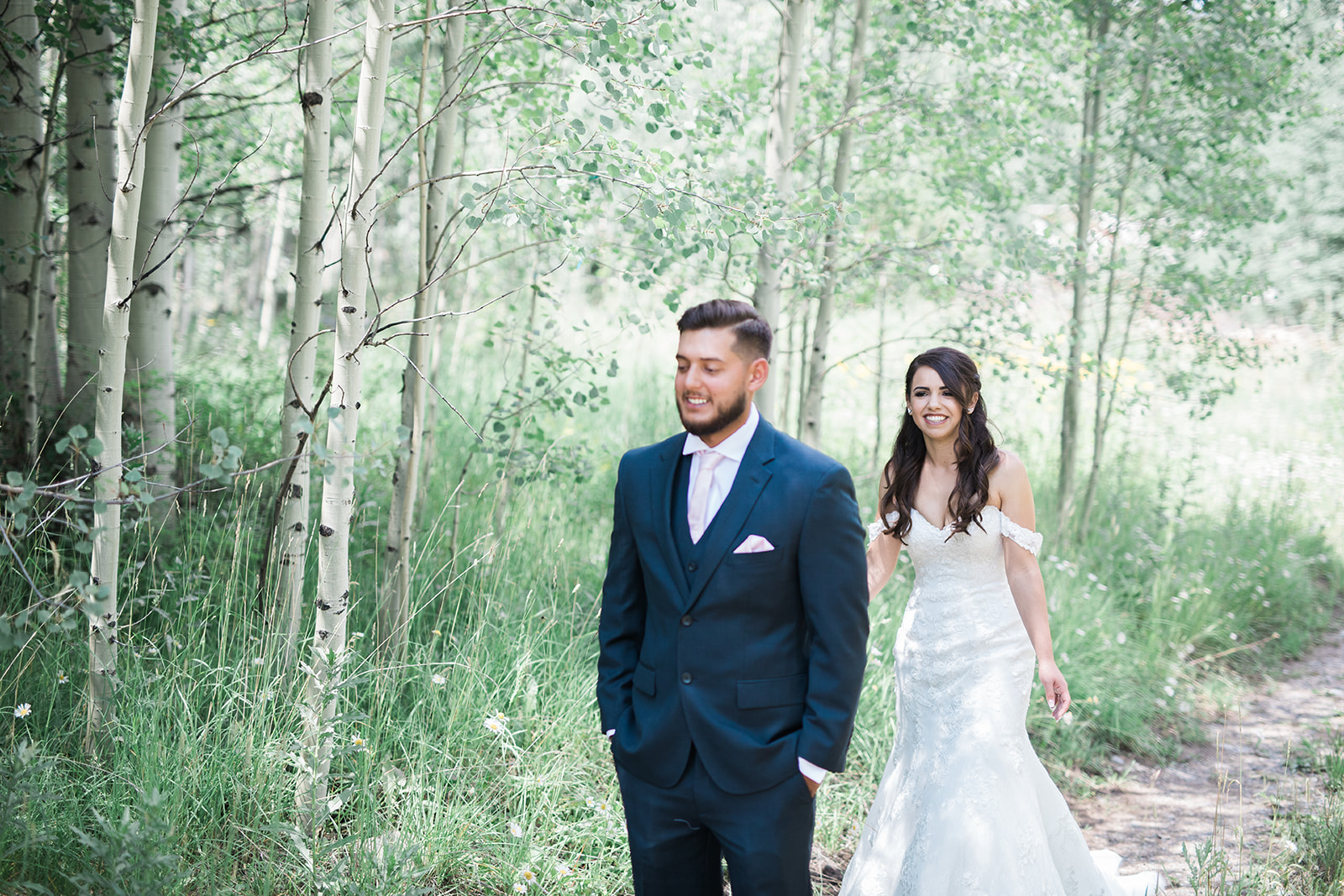 Silverpick Lodge bride walks up behind groom for first look in Durango Colorado
