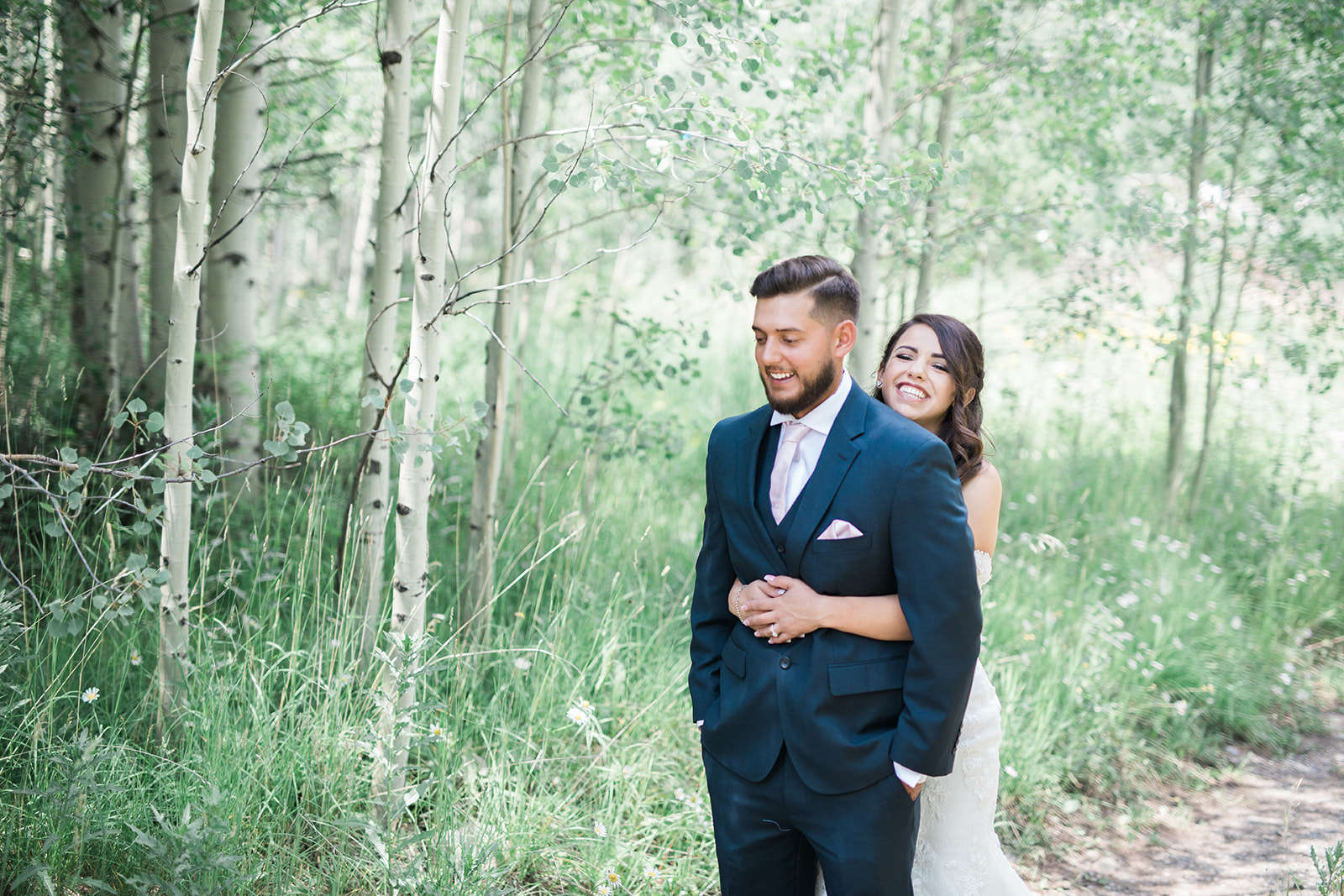 Silverpick Lodge bride walks up behind groom for first look in Durango Colorado