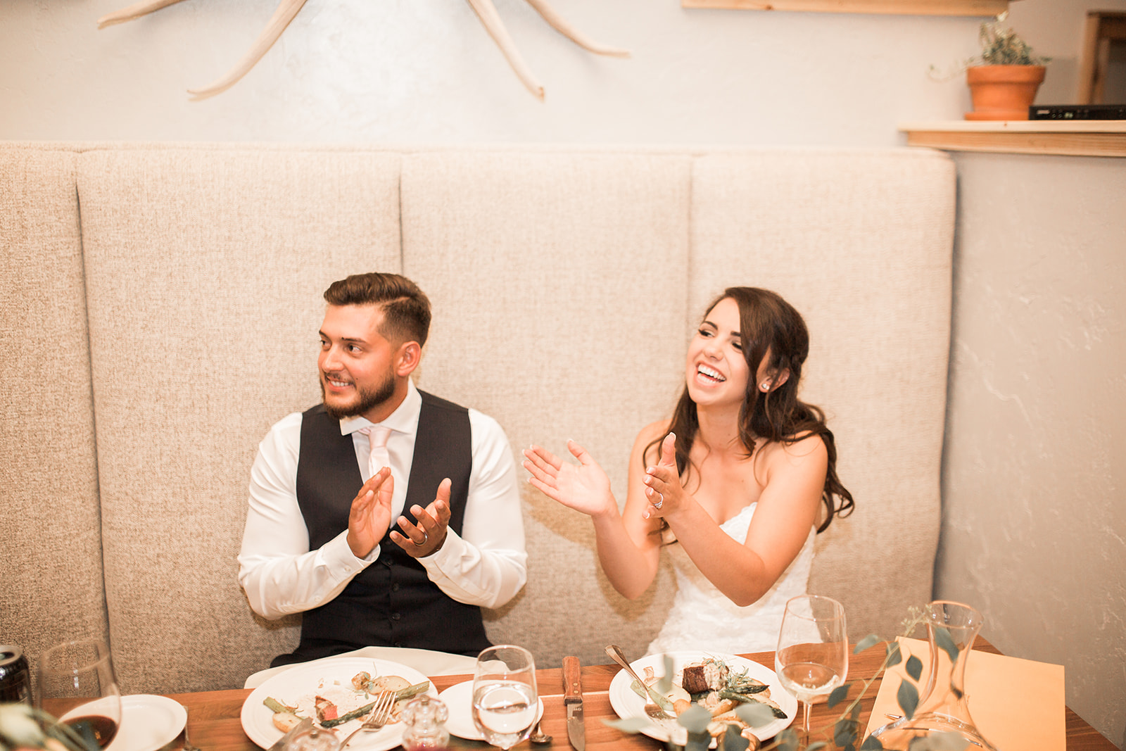bride and groom laughing during toast at reception