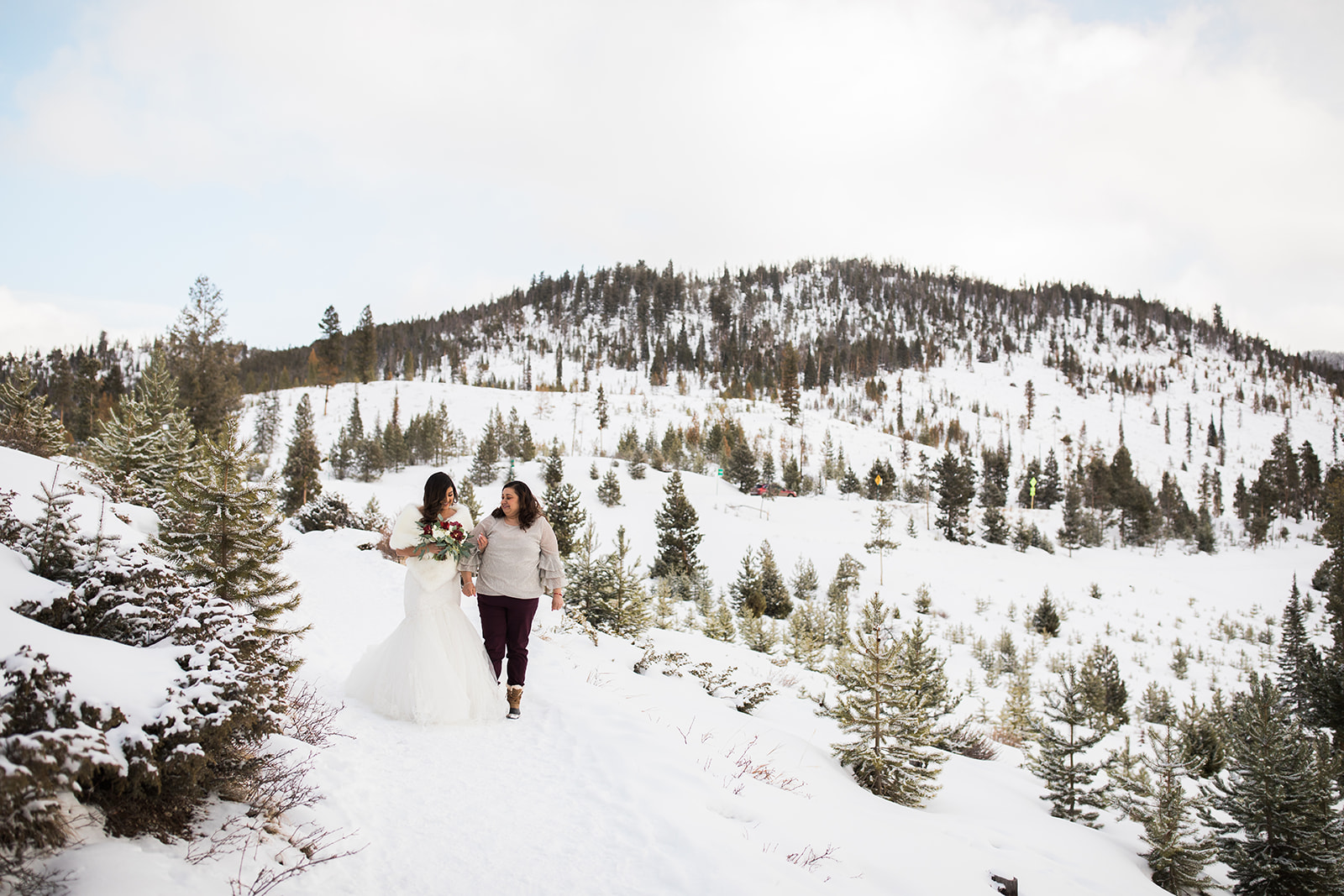 bride and mom walk in snowy Colorado mountains for Sapphire Point elopement