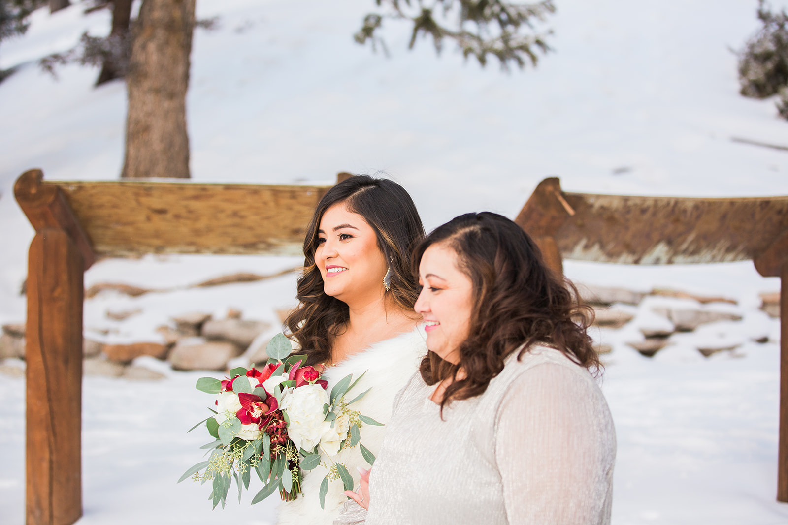 bride and mom walk in snowy Colorado mountains for Sapphire Point elopement
