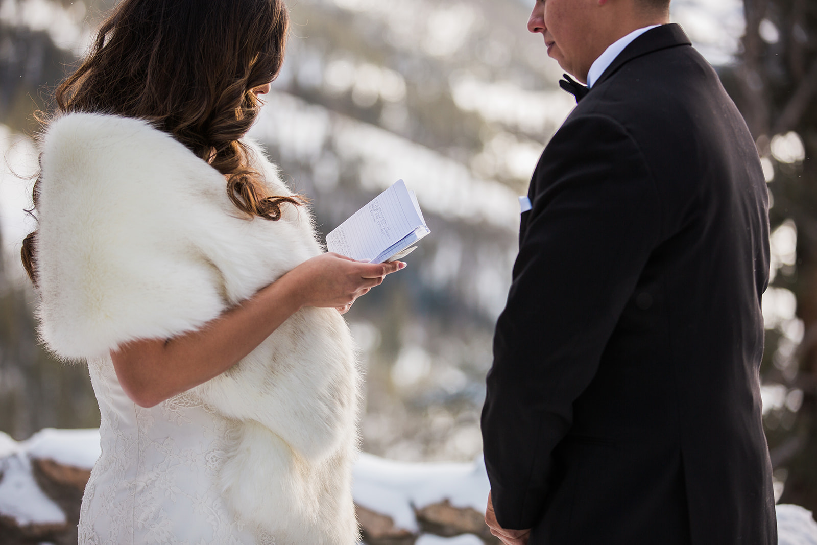 bride reads vows to groom in snowy Colorado mountain elopement