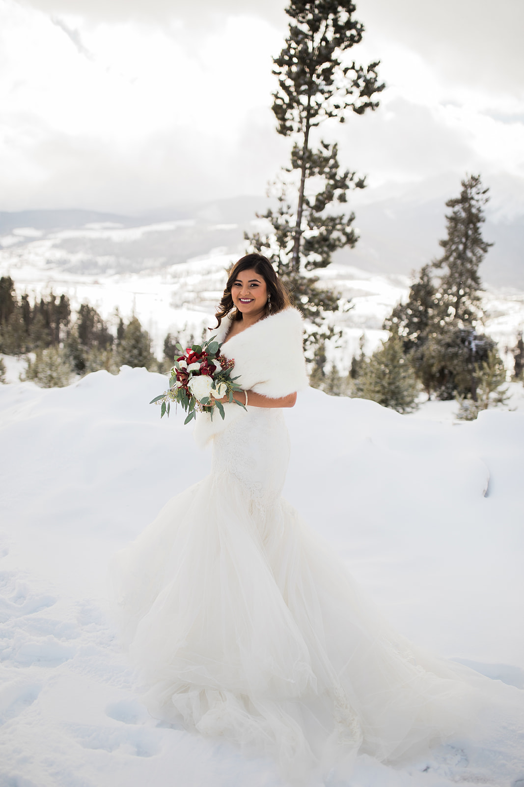 bride portrait in front of snowy Colorado mountain vista