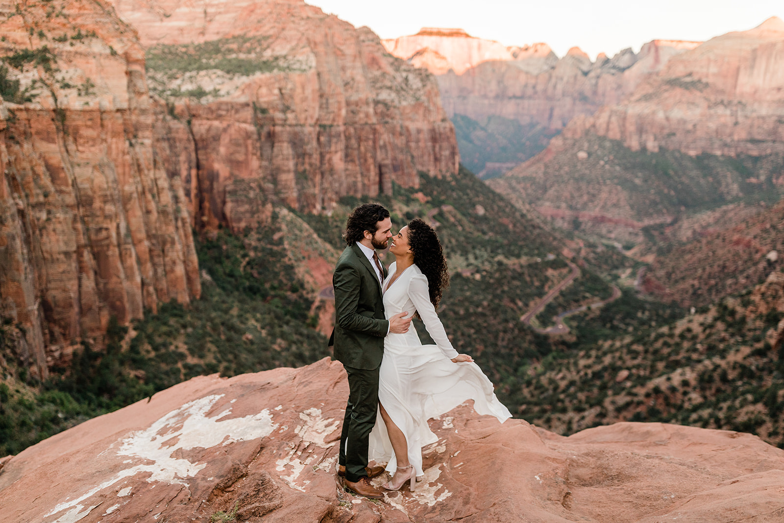 engaged couple in front of Zion overlook during adventure session