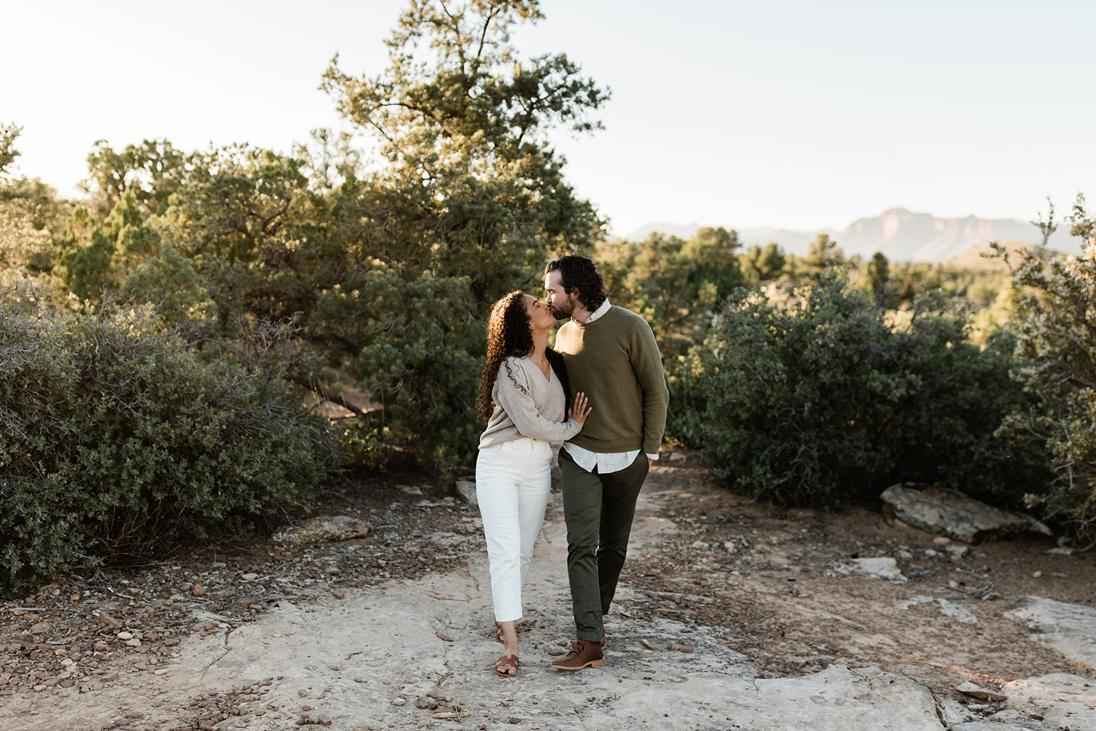 engaged couple strolls in Zion Utah sunshine during adventure session