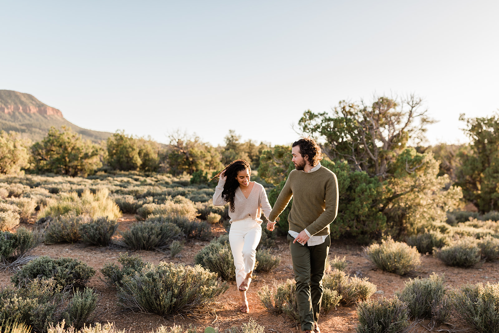 engaged couple strolls in Zion Utah sunshine during adventure session