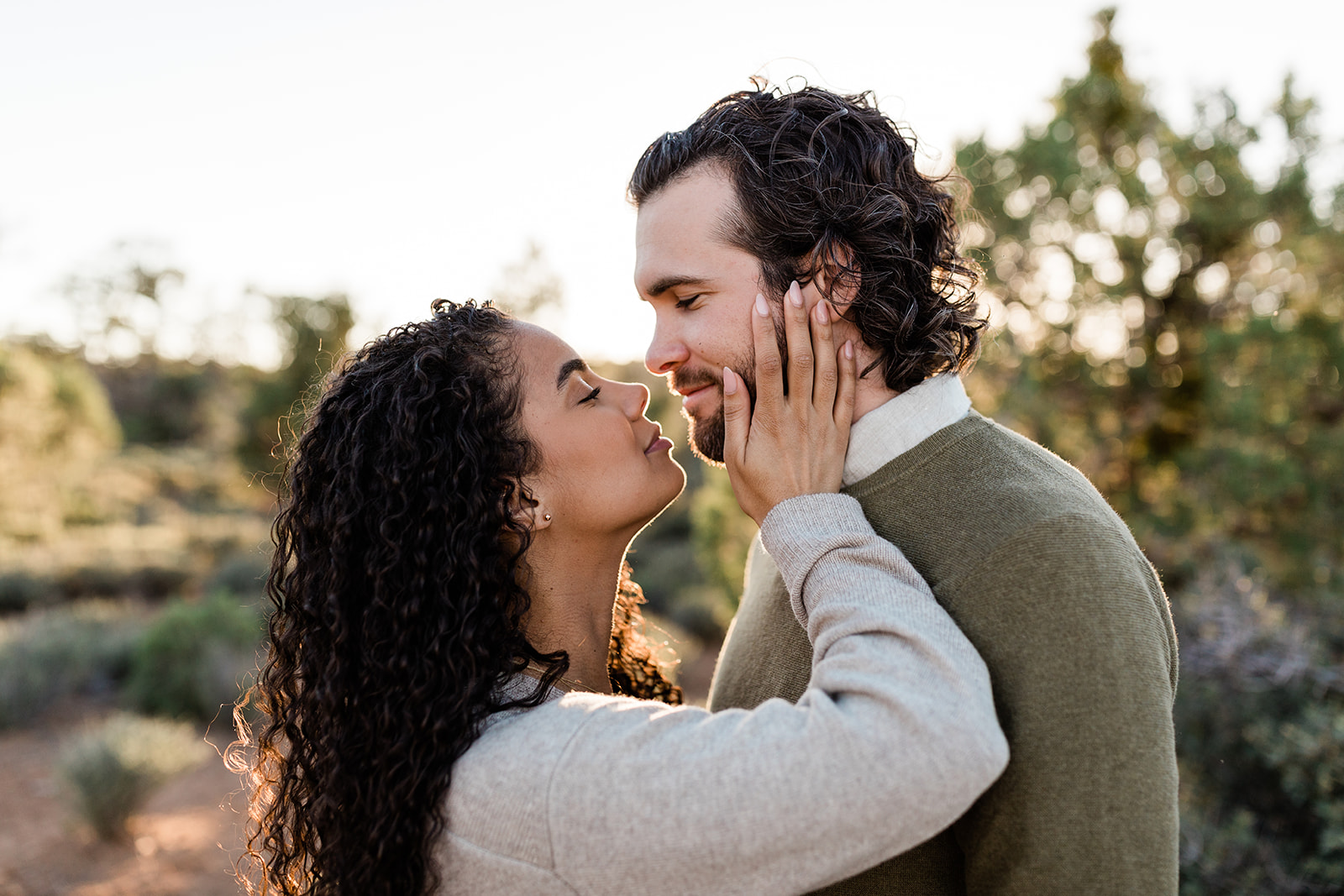 closeup on couple kissing during adventure engagement session